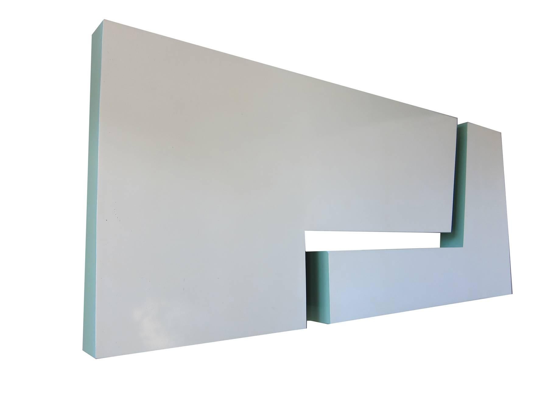 Large, two-piece modular sculpture created by Richard K. Schwartz, circa 1974. Geometric shapes hang flush to wall and are of two tones, sea foam fronts with darker green sides. They are comprised of painted lacquer over composite foam. Sculpture