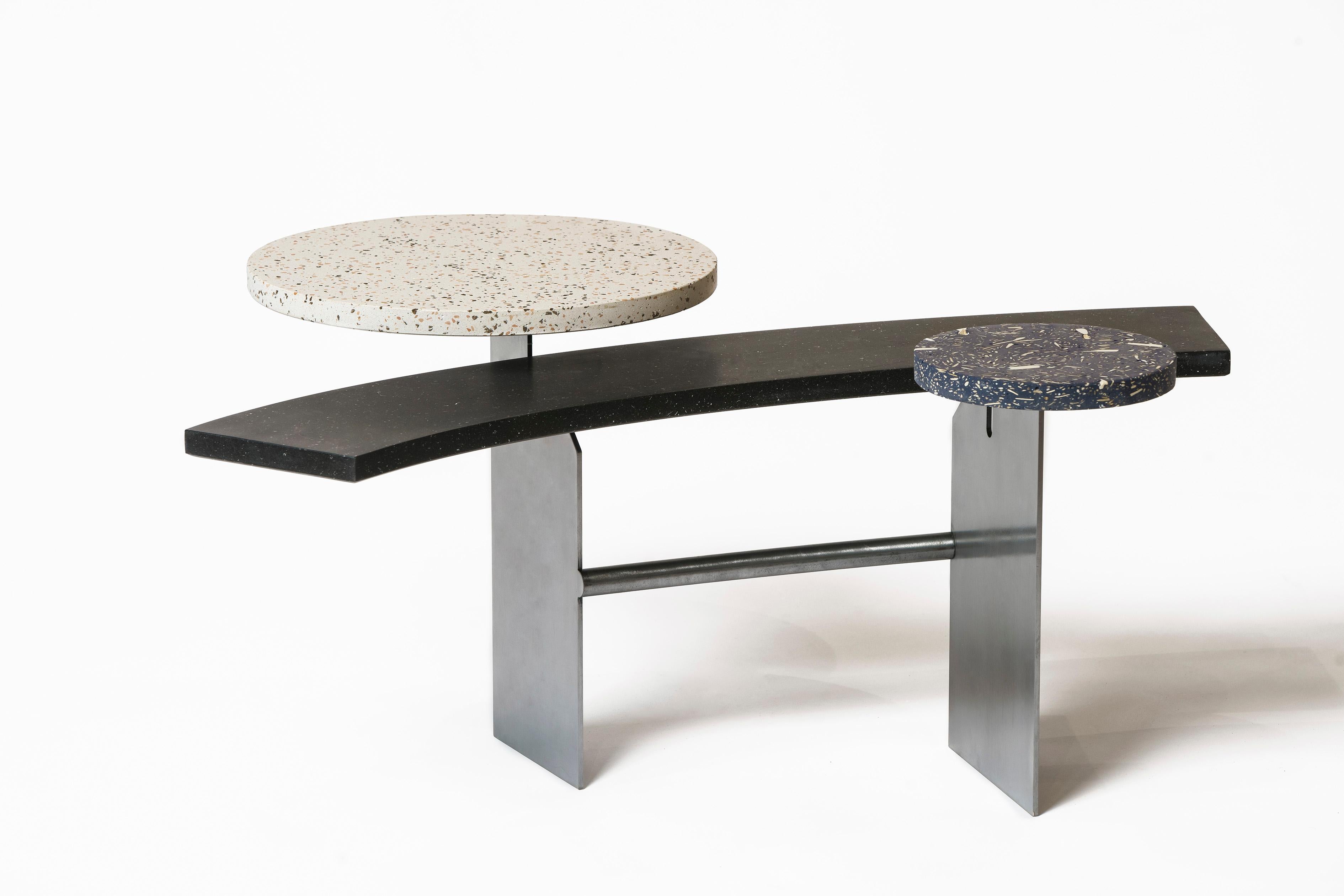 Large disc in white quartz with clay and boiled cork inserts, central bar in natural blue bio-hemp and small quartz disc entirely made with recycled terracotta aggregates.

“It is a research of the contrast and harmony between the solid/rigid, and