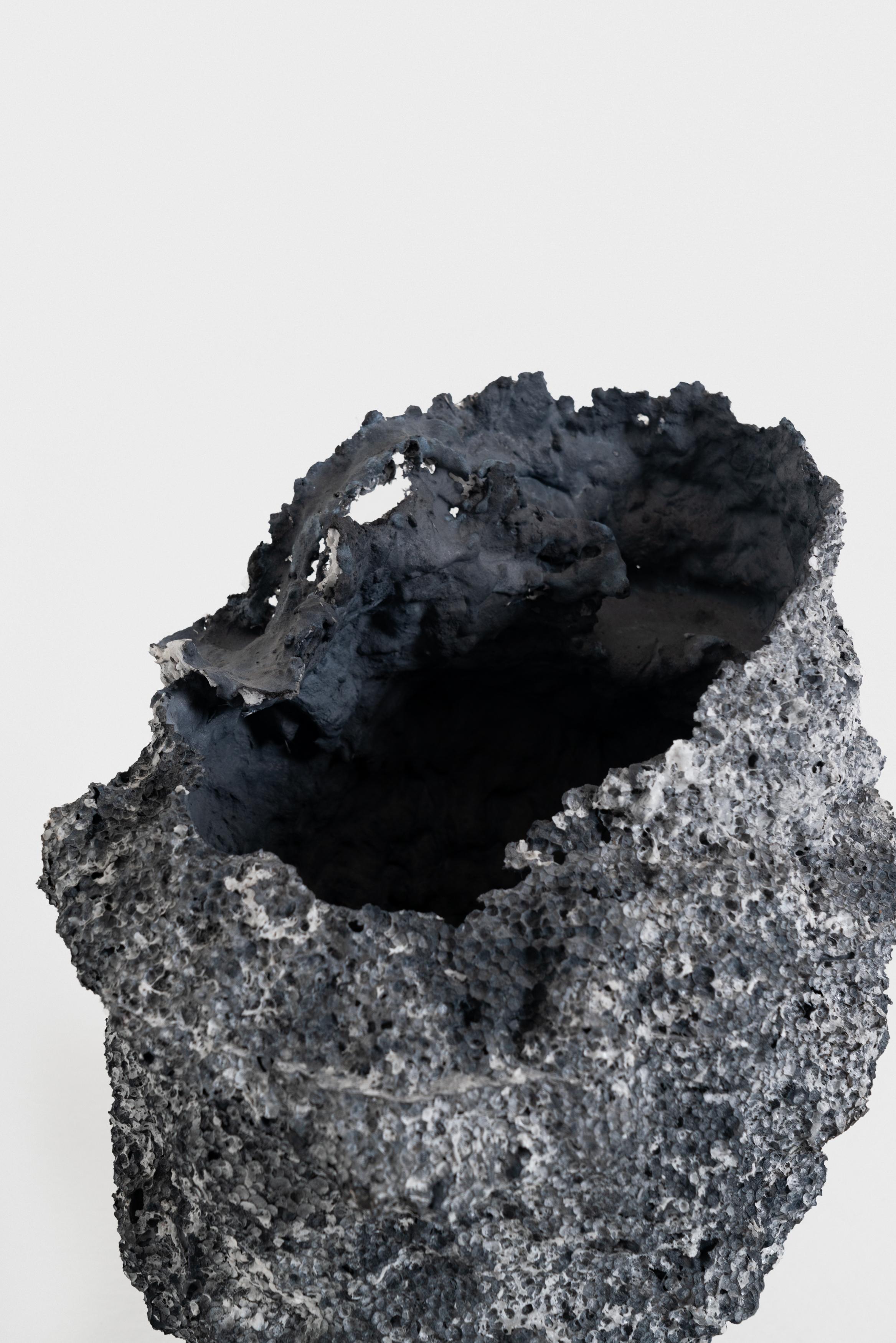 FDV is a collection of sculptural vases literally emerging from a block of Polystyrene. The block is first melted on the inside through acetone to obtain a partially controlled void, where the flowing of a mass of concrete leaves some of its fluid