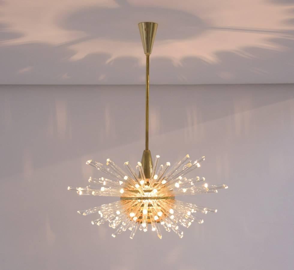 This fantastic ‘Miracle’ chandelier was designed and produced by Bakalowits, Austria in the 1960s.
The spherical brass body and the crystal glass rods illuminate the whole room, at the same time it throws a corona of light on the ceiling.
All the