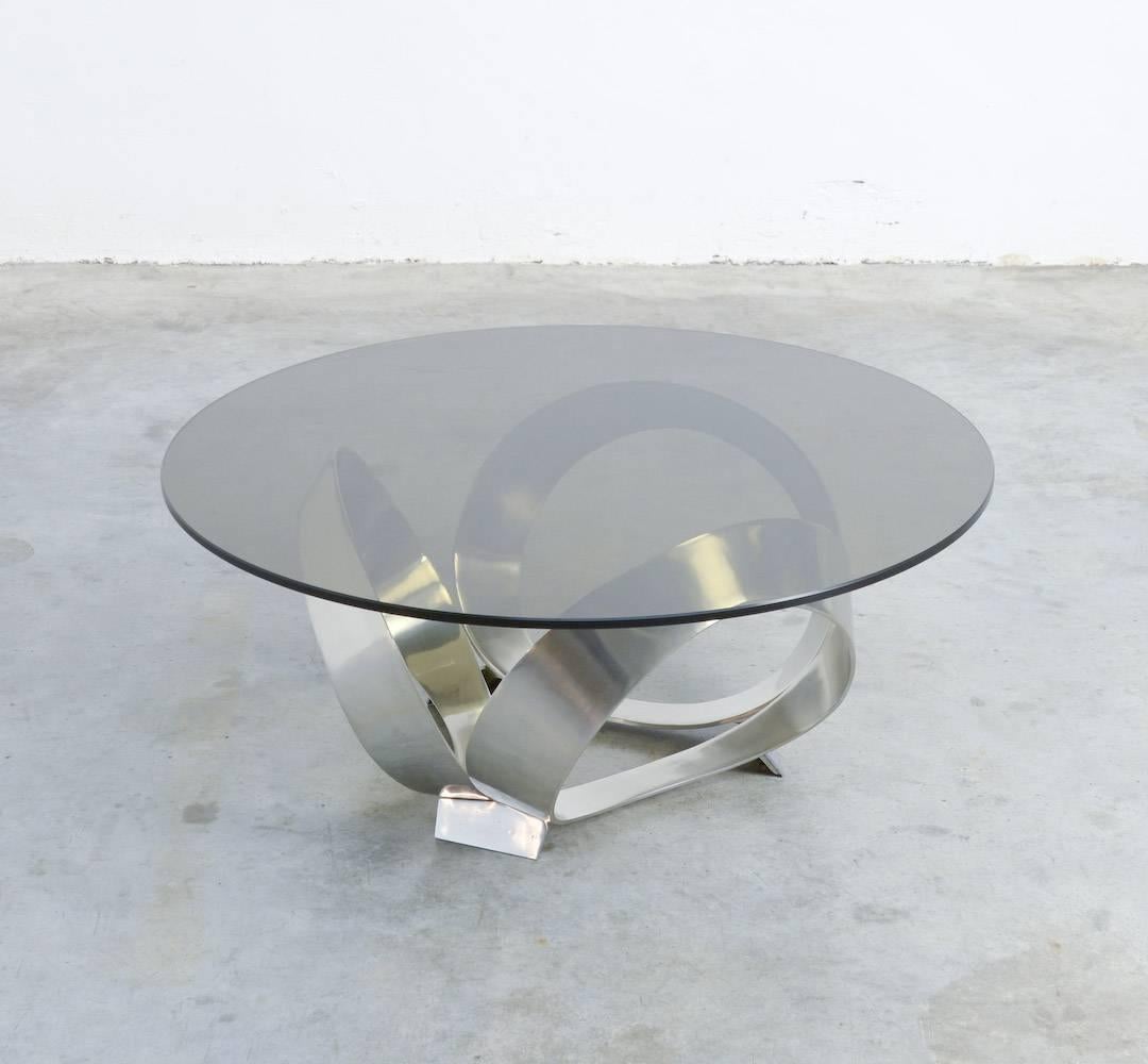This glass coffee table Diamond was designed by Knut Hesterberg for Ronald Schmitt in Germany. It is a great 1960s design.
The cast aluminum base is carrying the original fume glass top.
This table is in good vintage condition. The top has some