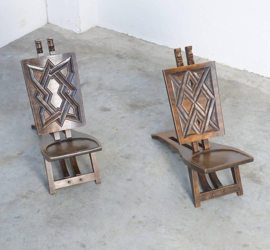 These African Chief chairs are probably manufactured in Katanga, Congo in the 1950s-1960s.
They are handcrafted, made of massive wood and carved with geometric motifs.
These special chairs are very decorative in an eclectic interior.
They are in