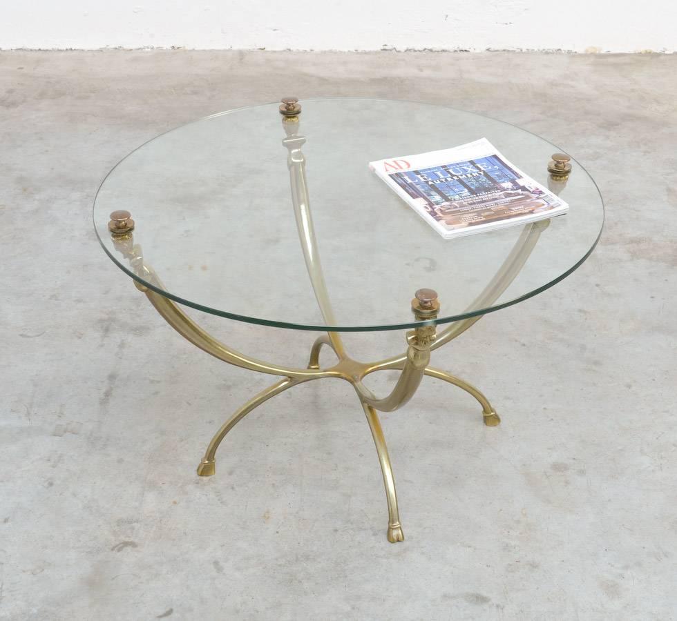This brass coffee table is a nice example of Classic inspired 1970s design.
Four satyr busts are carrying the glass top and look how nice the goat hoof feet are!
This Classic table is in perfect vintage condition, with a new glass top.