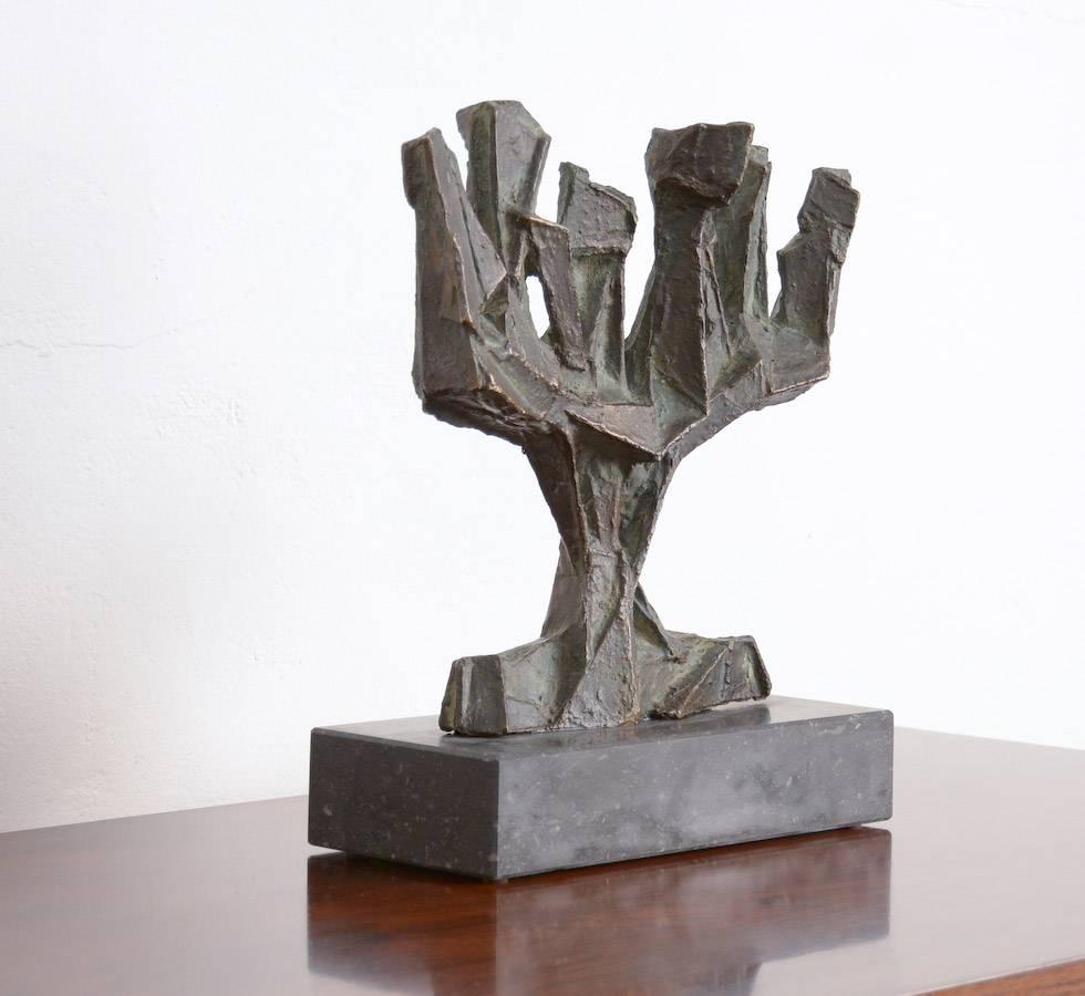 This bronze abstracted tree sculpture is fixed on a black marble pedestal.
The rough texture creates a dynamic surface.
This sculpture is in perfect condition.