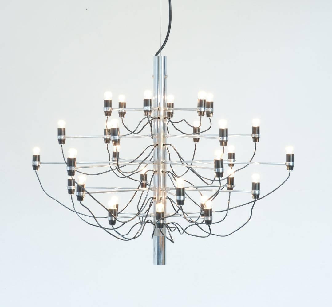 This iconic chandelier model 2097/30 is designed by Gino Sarfatti in 1958 and produced by Arteluce, Italy.
For this chandelier, Sarfatti was inspired by the archetype of the ancient chandelier.
The many chrome-plated steel arms are screwed