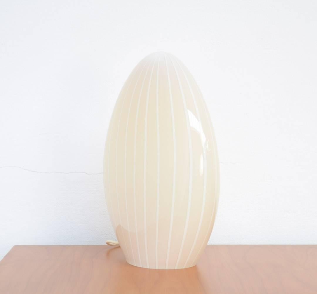 This crystal glass table lamp is made in the workshops of Murano, Venice in the 1960s.
It is a beautiful egg shaped lamp made of very thick glass.
This Murano glass lamp is in mint condition.