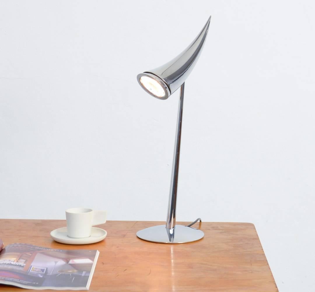 This horn-shaped Ara table lamp is designed by Philippe Starck for Flos in 1988.
It was named after his daughter.
This classic Starck design incorporates bold sweeping lines that give it a highly distinctive sculptural presence.
The on/off switch