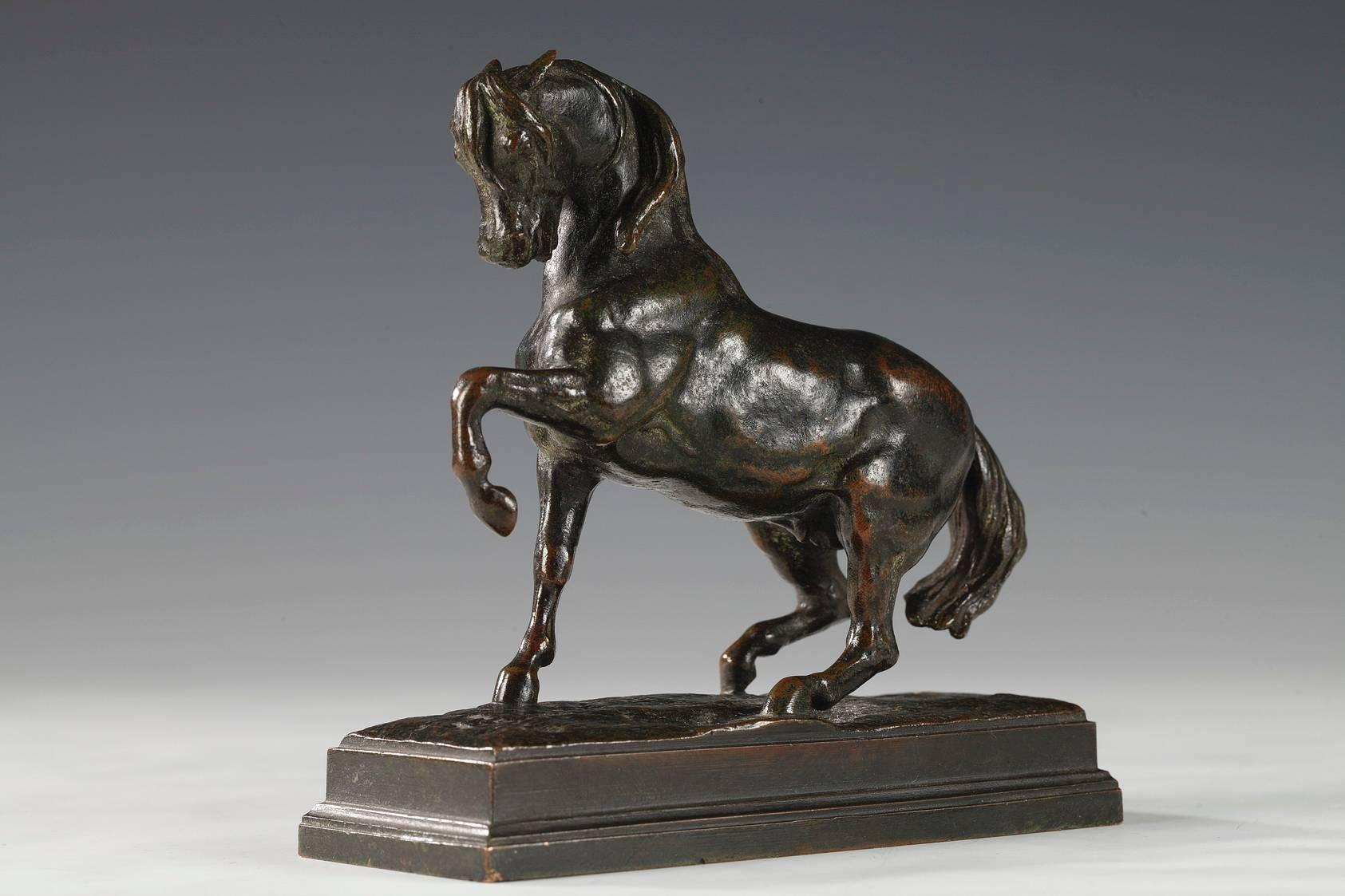 Beautiful green patina bronze of a horse with left foreleg raised on rectangular base with cast signature 