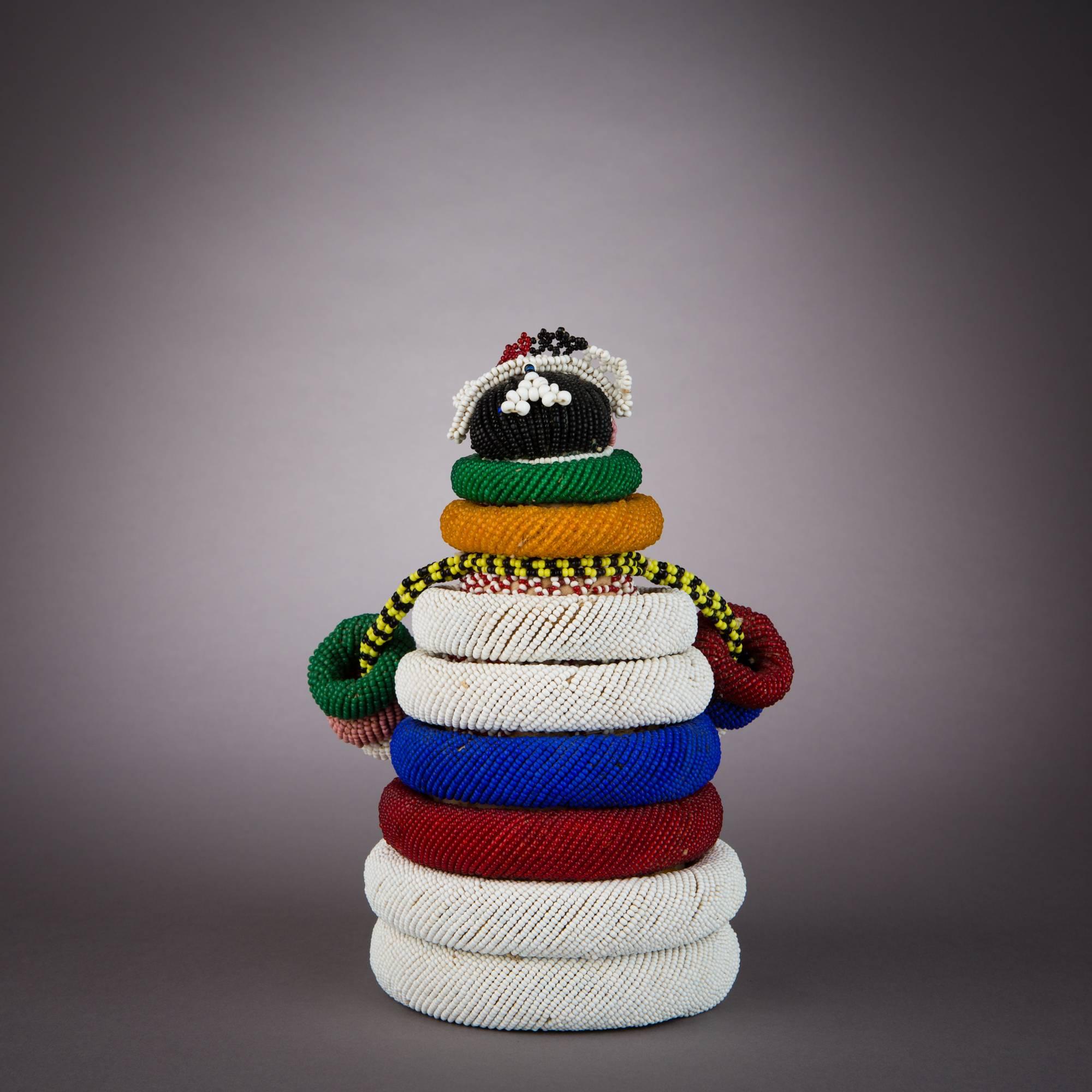 Ndebele beaded fertility dolls are given to young girls when they attend initiation school. The doll is cared for and cherished until the woman's first pregnancy. According to custom, the child figure must be given away, sold or destroyed after the