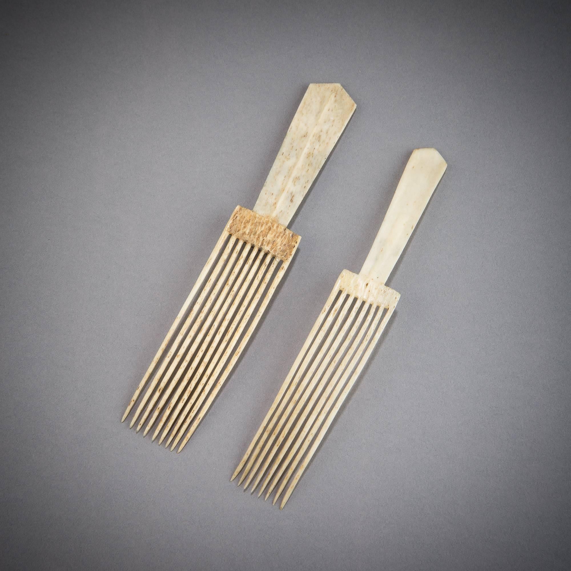 A fine pair of Zulu combs decorated with crosshatched incisions. Ash would be rubbed into the incisions in order to create these darkened designs. When not used, these combs were often worn in the hair.

Due to the fragile nature and age of these