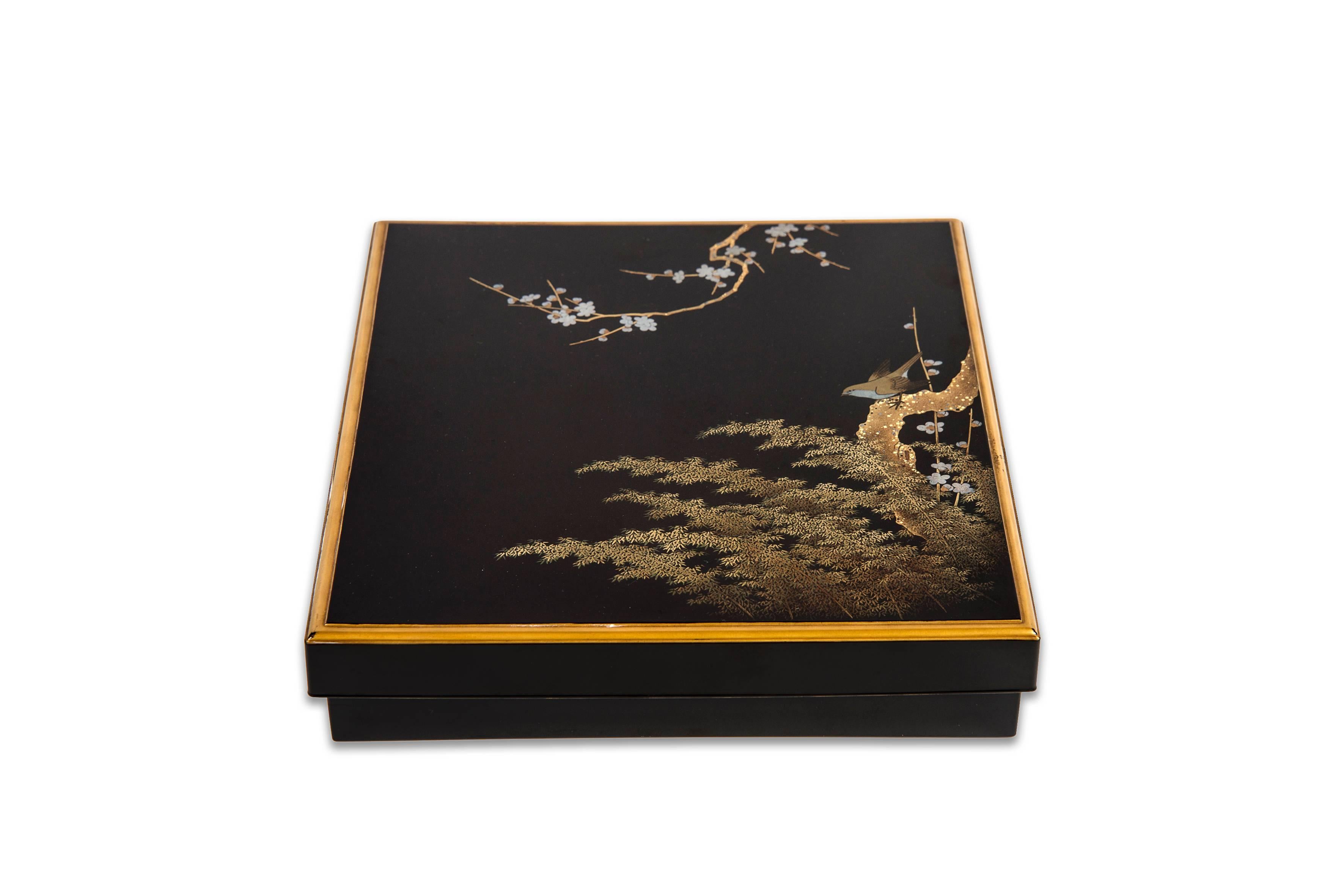 Suzuribako (writing box), the lid decorated at the outside with a decoration of a bush warbler (uguisu) perched on a prunus tree above a bamboo grove in gold and silver maki-e lacquer. The inside of both lid and box with sprinkled gold lacquer