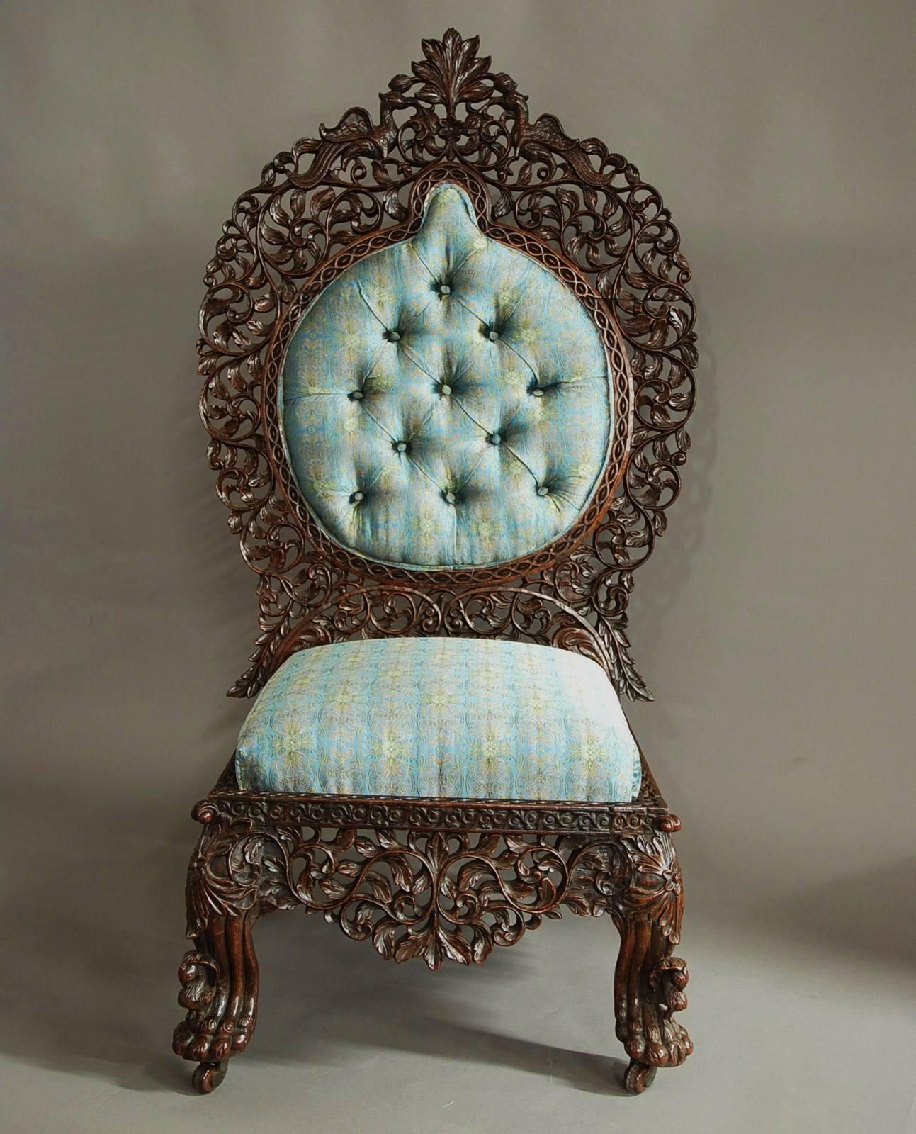 A mid-19th century superb quality Anglo-Indian rosewood profusely carved and upholstered side chair, probably from the Bombay region of large proportions.

This chairs consist of an elaborately carved back with central leaf decoration to the top