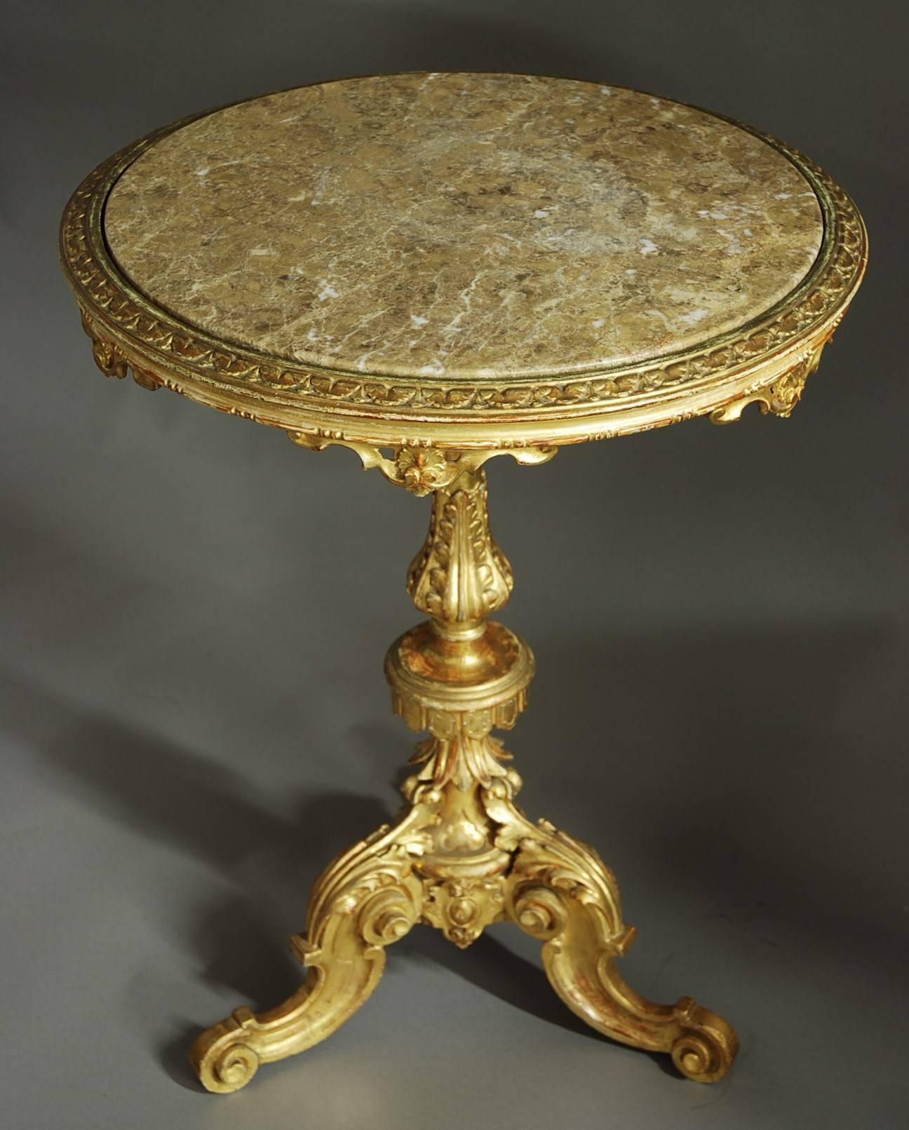 A highly decorative late 19th century Italian carved pine giltwood marble-top centre table.

The table consists of a neutral tone mottled marble drop-in top with a carved moulded edge and carved embellishments to the underneath.

This leads down