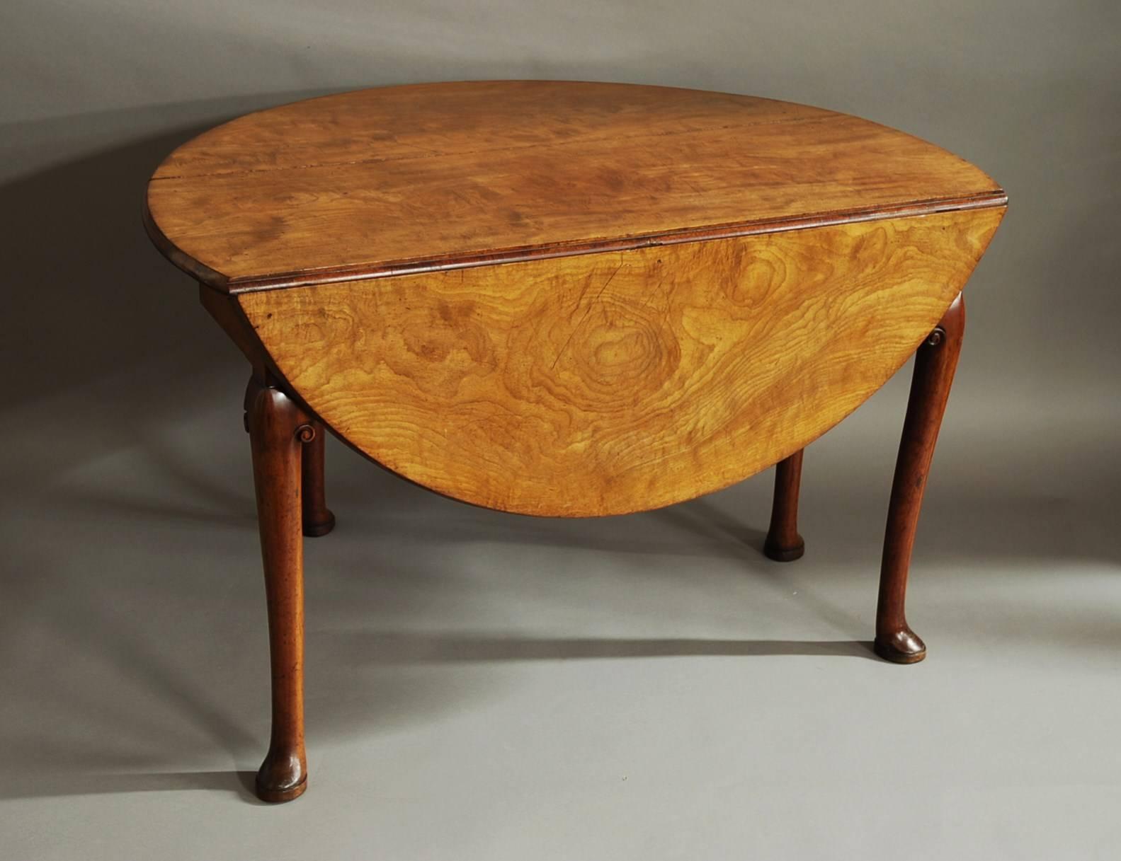 A mid-18th century solid well figured mahogany circular pad foot table in good original condition with fine and faded patina (color).

This table consists of a solid well figured mahogany top with a moulded edge leading down to four, tapered round