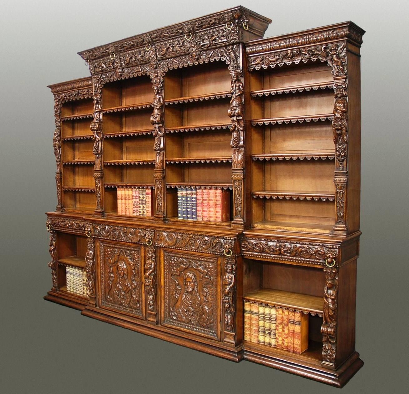 An exceptional quality mid-19th century oak breakfront antiquarian open bookcase in the Renaissance style of superb patina (color).

This superb bookcase consists of a slightly taller central section, of breakfront form, with a finely carved
