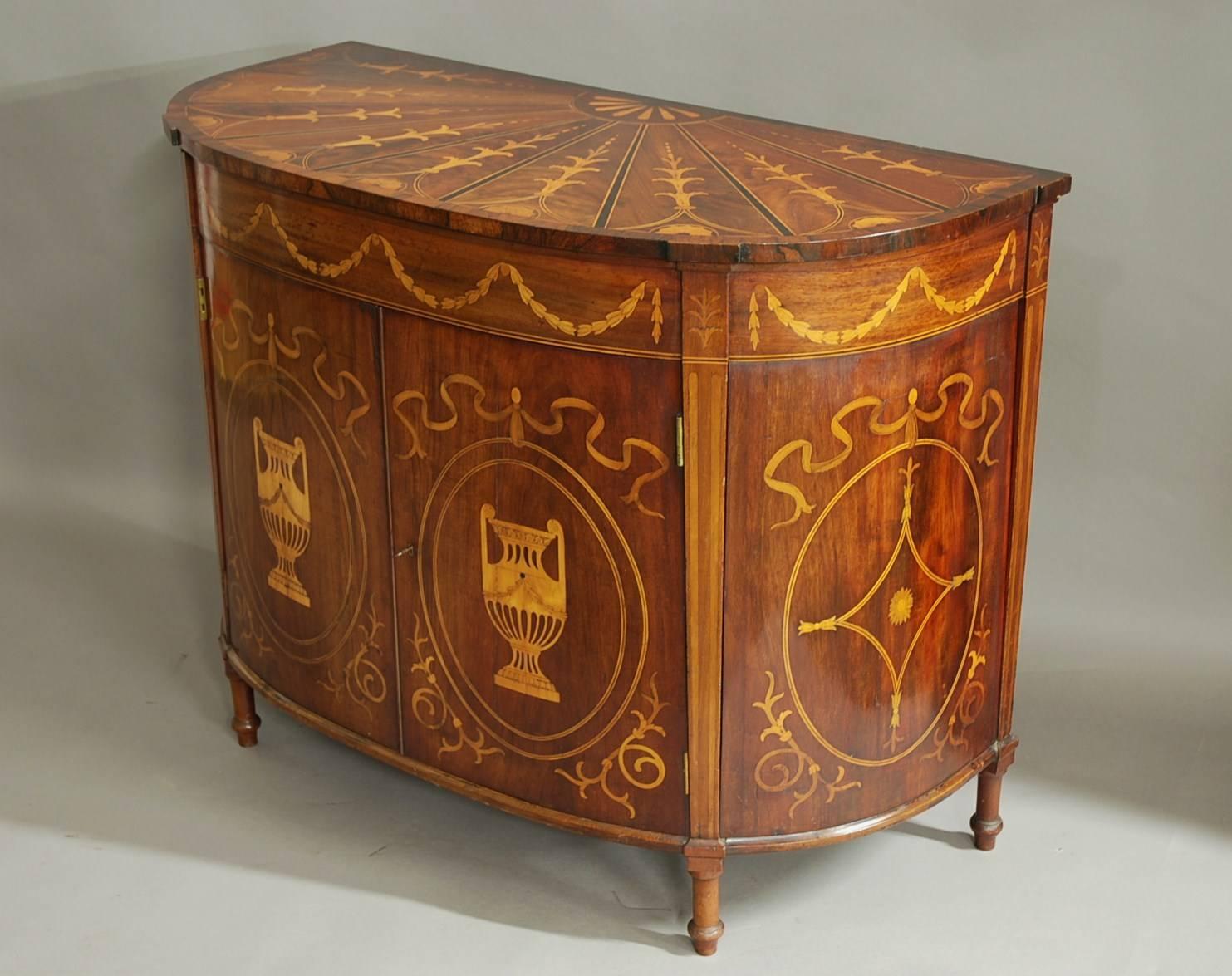 A late 19th century mahogany commode in the Classical style of good patina.

The mahogany top consists of a small inlaid fan decoration to the top leading to a large fan design that consists of eight segments with boxwood and ebony stringing. Each