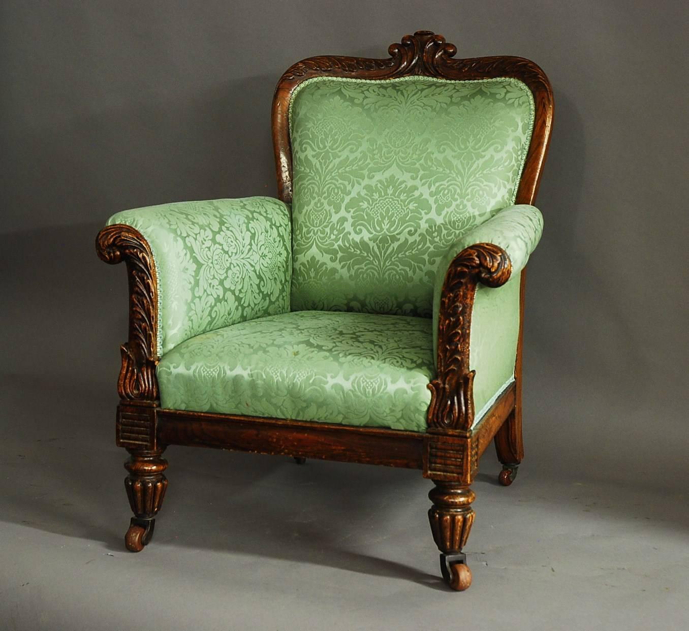 A William IV simulated rosewood upholstered armchair.

This chair consists of a beech frame painted with a simulated rosewood finish to replicate the grain of rosewood .

The back rail has a carved scrolling design to the centre with carved oak