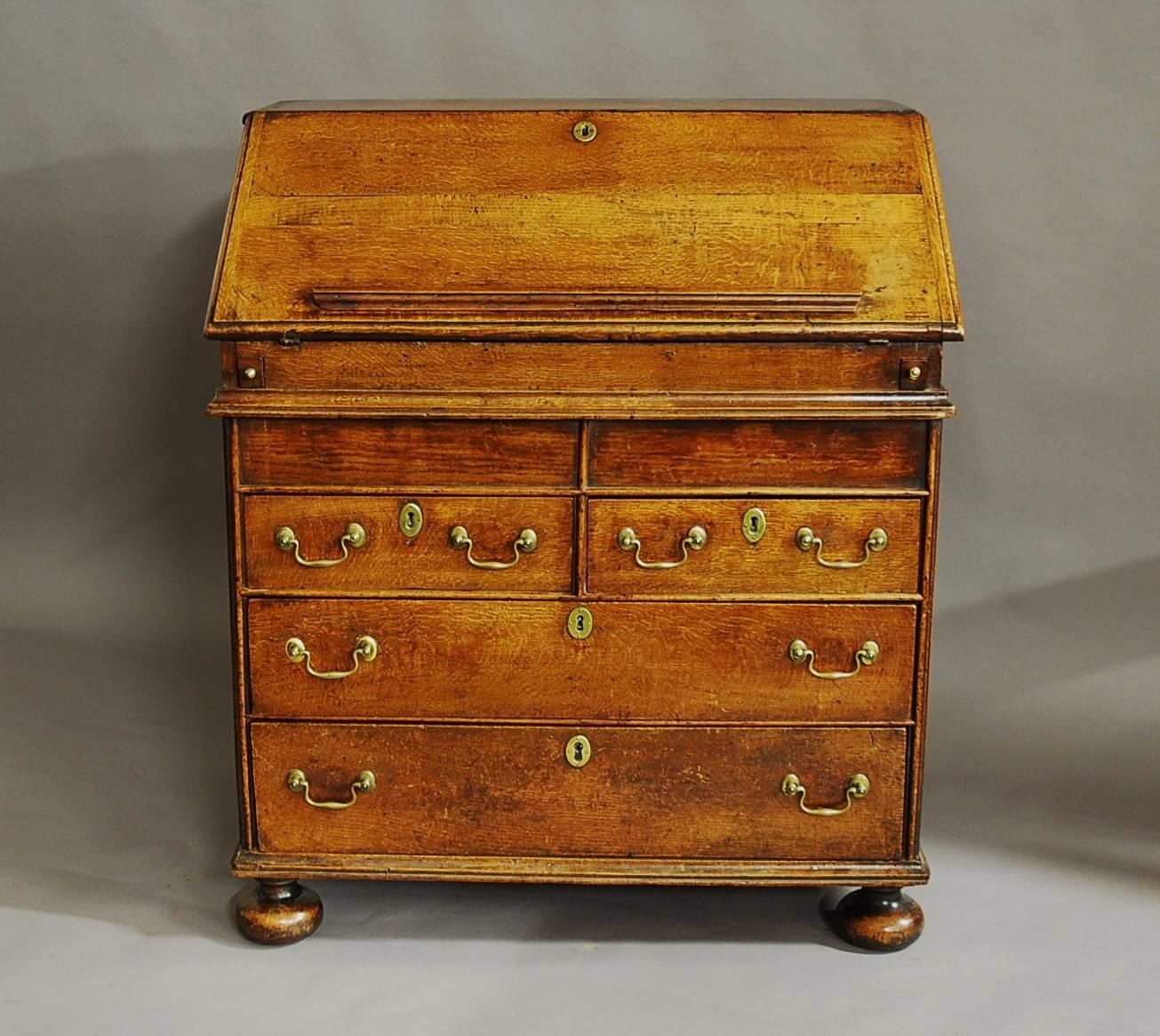 A rare William & Mary late 17th century oak bureau of fine, faded patina (colour).

The bureau consists of a solid oak top with a moulded edge leading down to a solid oak fall also with moulded edge and a moulded book rest.

The fall opens