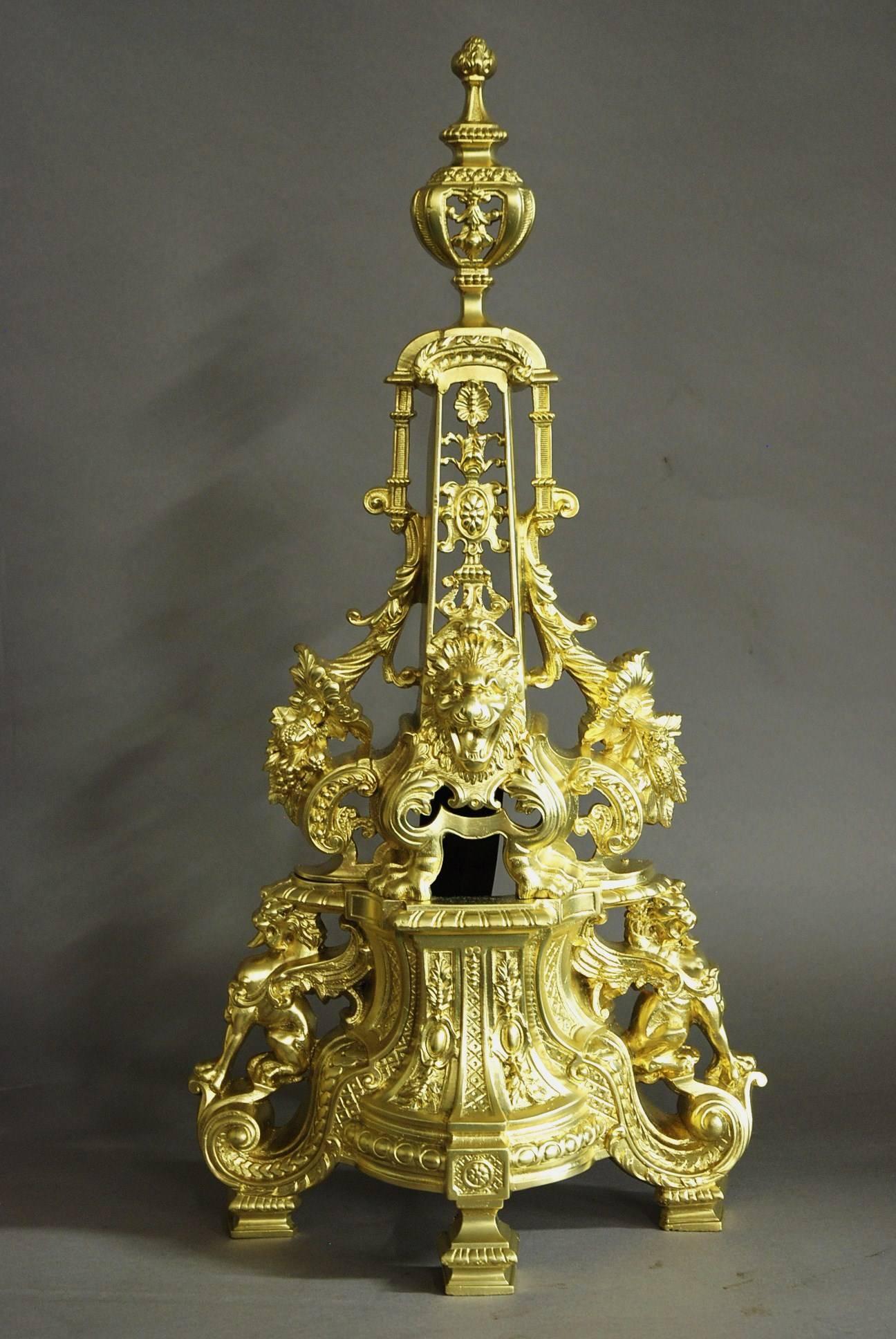 An extremely large and highly decorative pair of French 19th century brass chenets or fire dogs of superb quality.

These chenets are stunning pieces both due to their size and quality.

They consist of a decorative finial to the top leading
