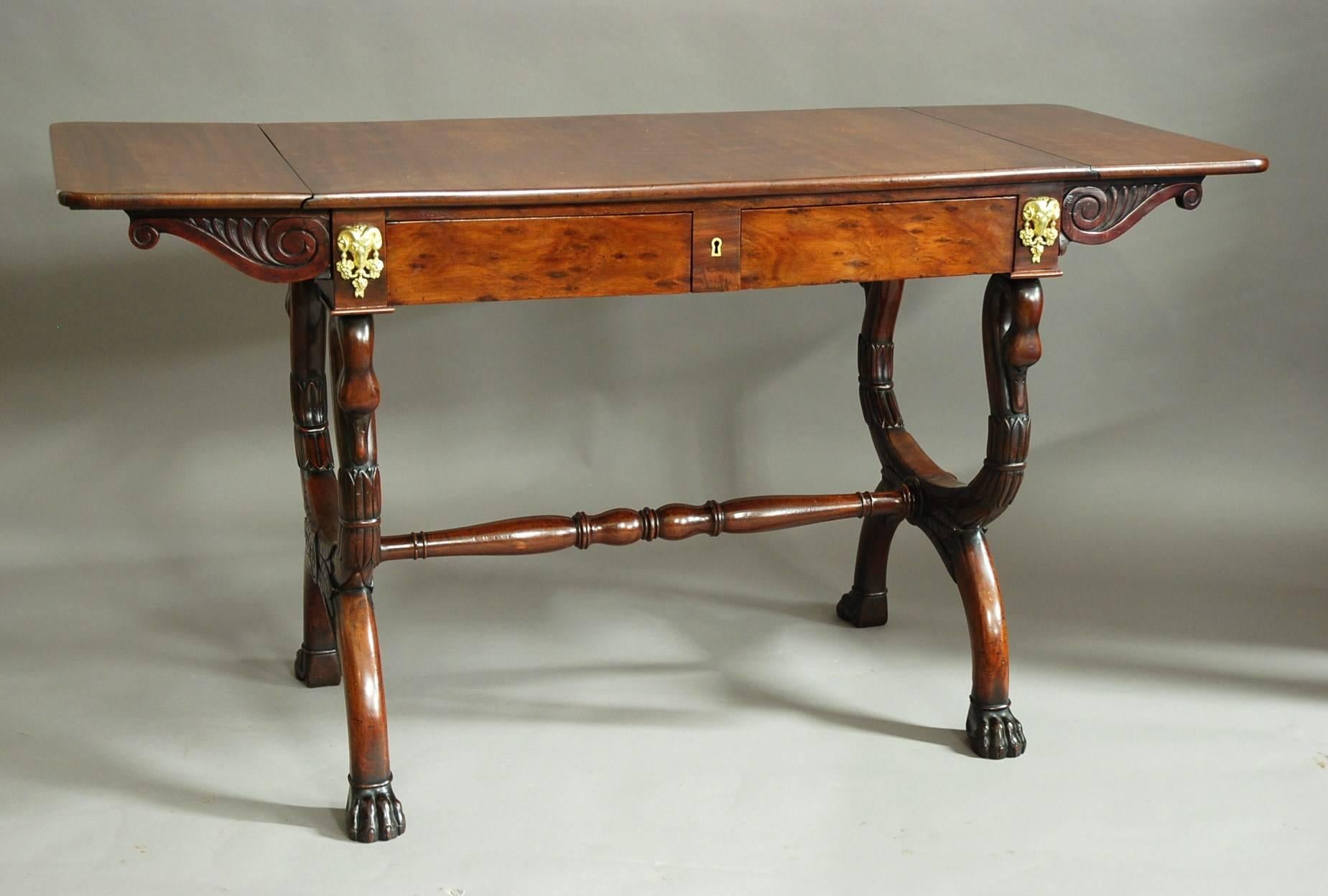 An early 19th century French Empire mahogany sofa table of superb patina (colour) and quality, attributed to Jean-Joseph Chapuis (1765-1864).

This table consists of a solid mahogany top with drop leaves at each end with carved scrolled