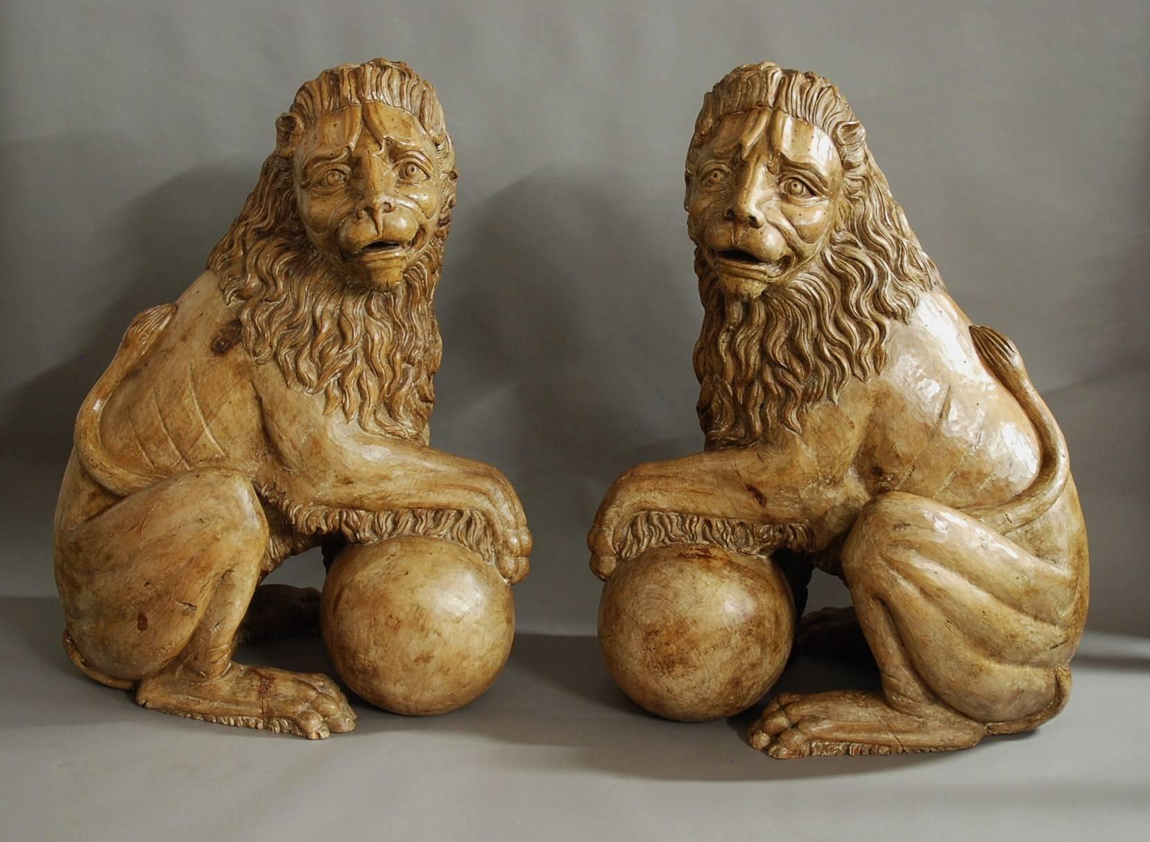 A magnificent pair of highly decorative 19th century Italian life size carved pine Medici lions.

These imposing figures are solid pine and are superbly carved, each lion seated with one front paw resting on a ball or sphere with head looking to