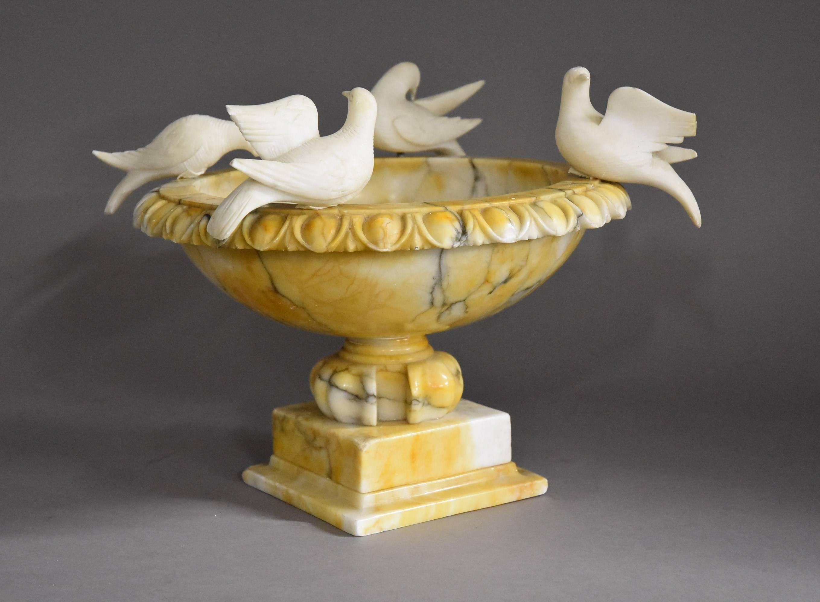 A highly decorative late 19th century alabaster tazza or birdbath. 

This tazza consists of four carved doves (symbolic of peace) surrounding the circular top with egg & dart carved decoration.

This leads down to the decorative carved base