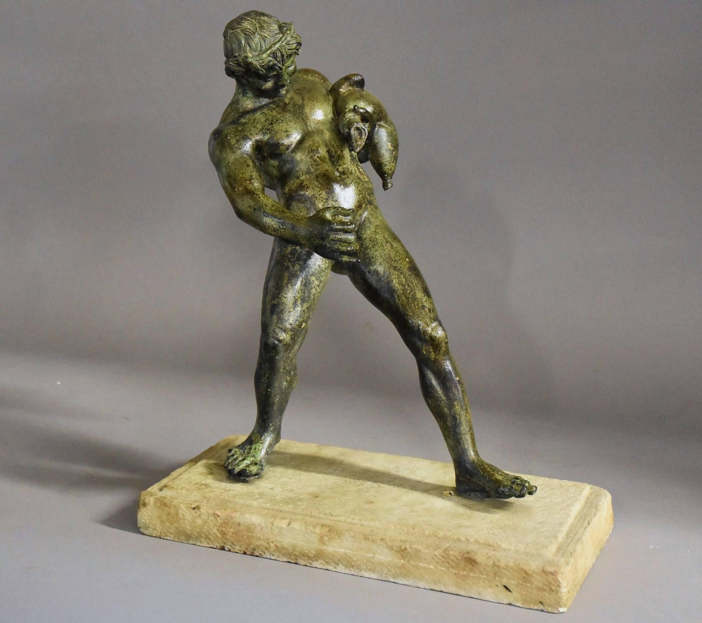 A good quality late 19th-early 20th century Grand Tour style bronze of Bacchus (God of wine), after The Antique, with green patination mounted on a rough cut marble base.

This figure is depicted holding a wine skin in his left hand and is