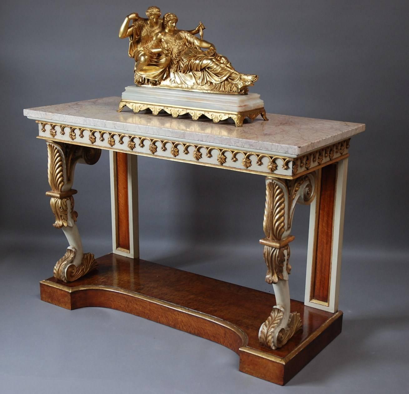 A rare English Regency gilt & painted burr maple console table with marble top.

The top consists of a rectangular cream veined marble top which is supported by the gilt, painted and burr maple base. 

The base has a carved, painted and