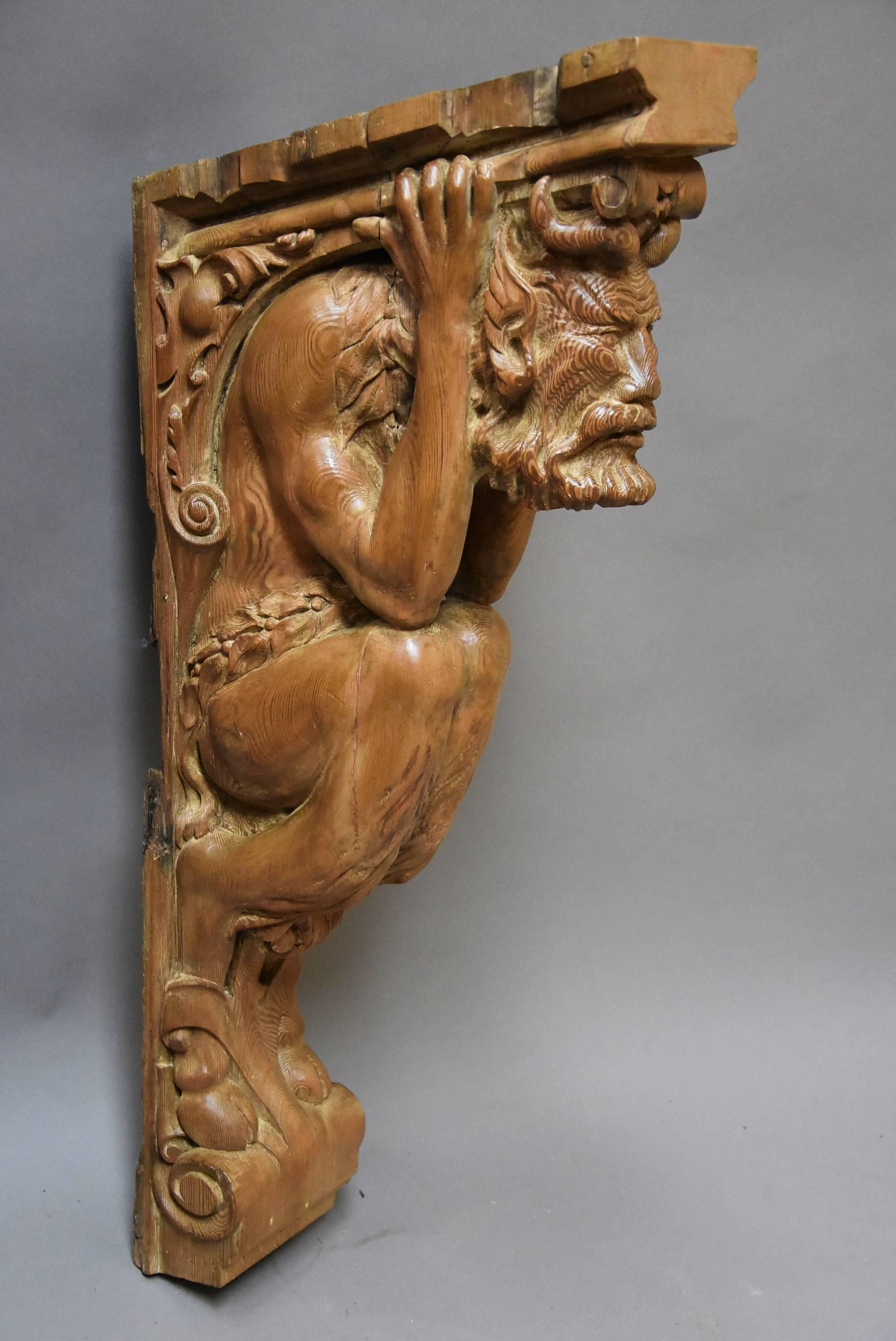 A highly decorative large superbly carved Continental large pine bracket in the form of a satyr, possibly Italian.

This imposing carving consists of a satyr holding onto the scrolling bracket above him, this bracket supporting the satyr, his