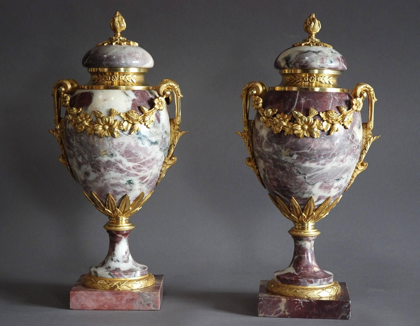 A superb pair of late 19th century fine quality Breche Violette marble cassolettes with finely chased ormolu-mounts in the Louis XVI style.

The cassolettes consist of removable marble lids with ormolu finial decoration to the top in the form of