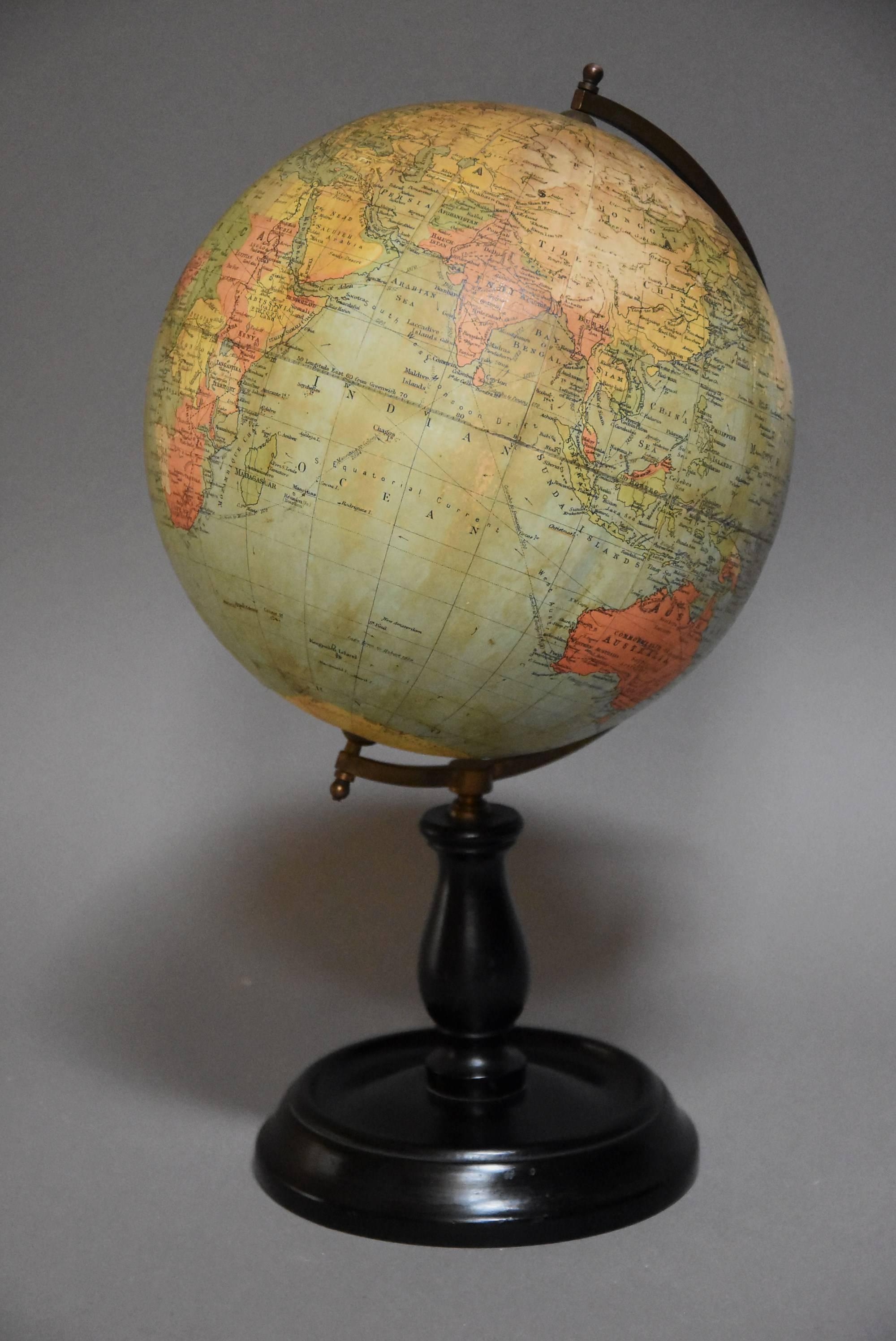 An early 20th century Philips British Empire terrestrial table globe.

This small globe is in original condition with brass axis allowing the lobe to fully rotate, supported on a turned and ebonised wooden base. 

This piece would be an ideal