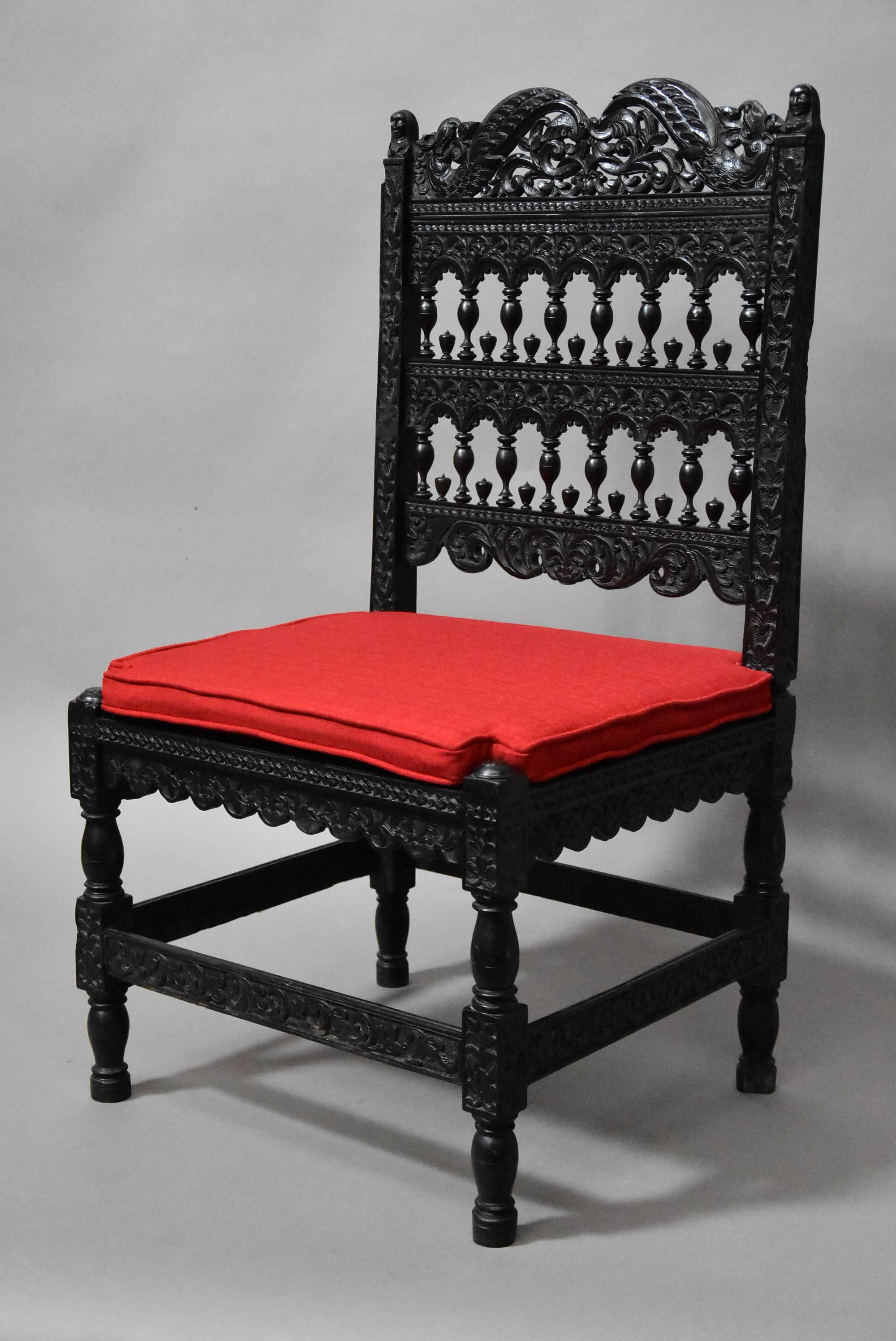 A superb quality late 17th century solid ebony chair with intricate carving from The Coromandel Coast, India.

This chair consists of a profusely carved back rail of scrolling foliate decoration with carved mythical beasts to either side.

This