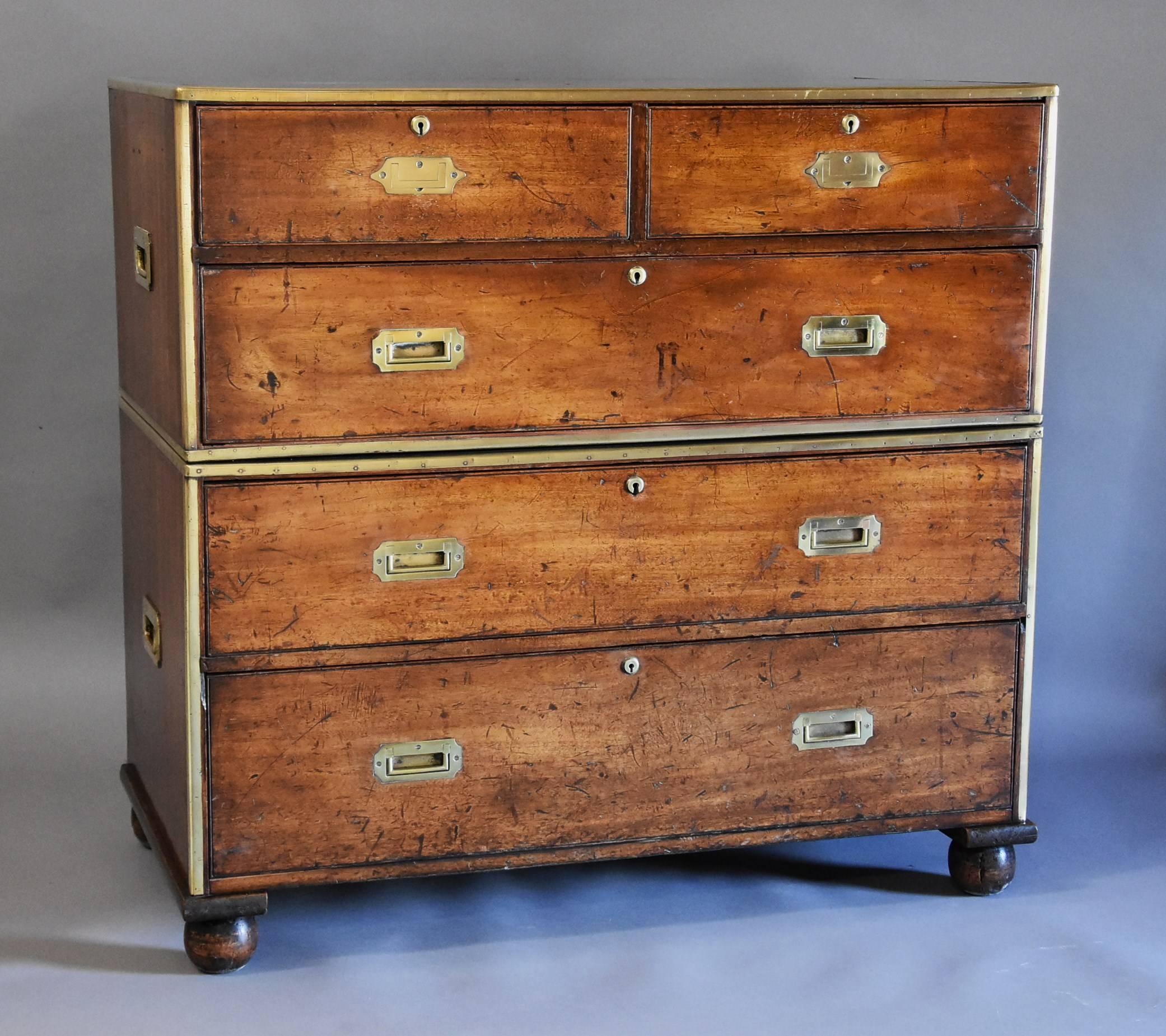 An English mid-19th century mahogany and brass bound military chest of excellent patina (color).

This chest of drawers consists of a solid mahogany top with brass edging leading down to two short over three long drawers.

The two shorter