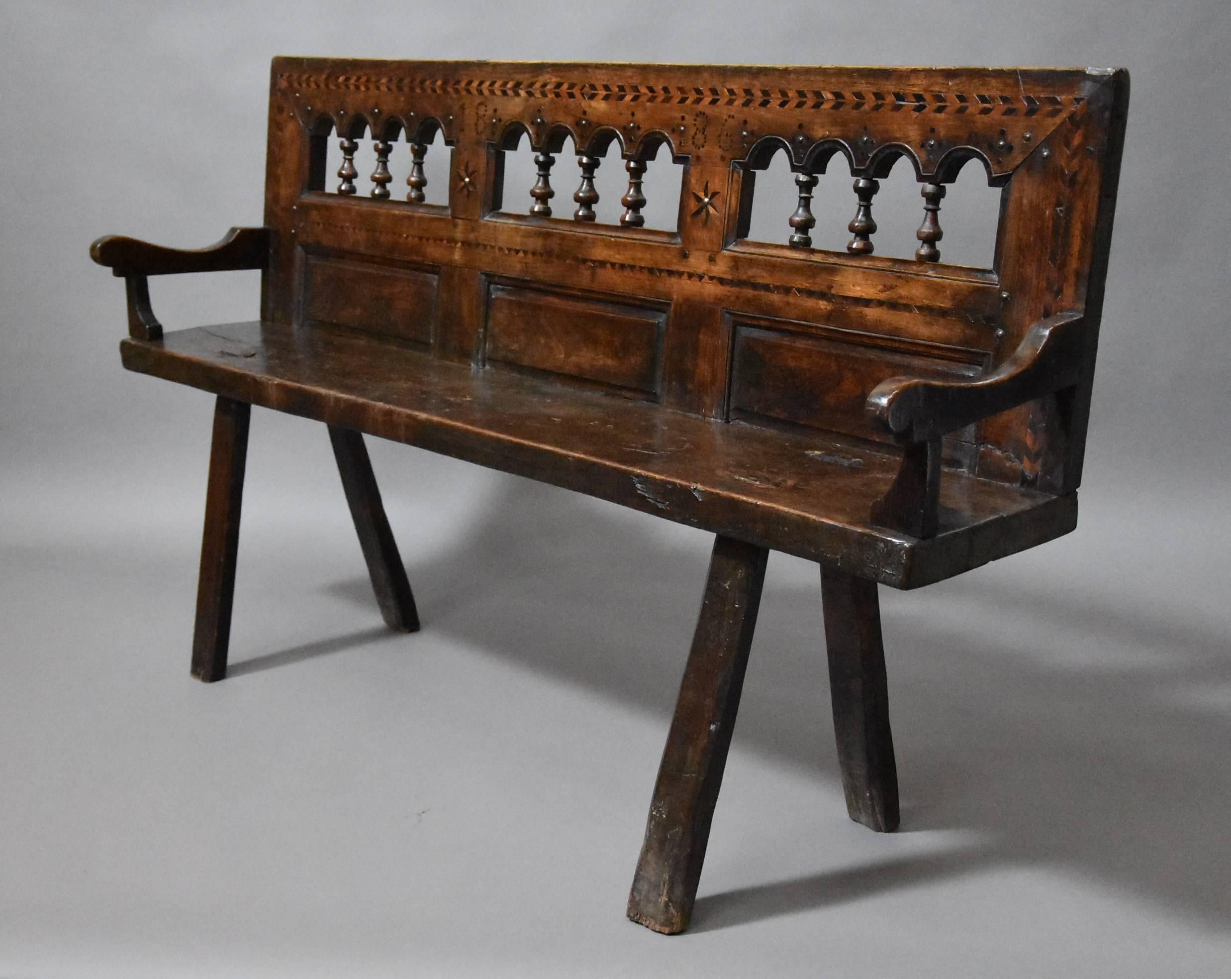 A late 19th century Breton walnut and elm bench of superb patina from Northern France.

This bench is typical of Breton style furniture due to the design on the back consisting of turnings and inlaid decoration often found on Breton beds and other