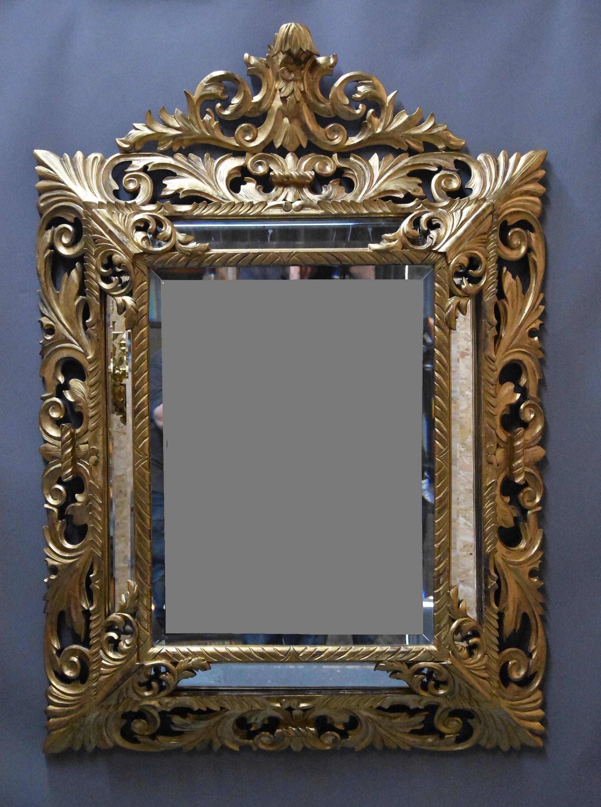A large late 19th century Italian, probably Florentine, superbly carved giltwood cushion mirror.

This mirror consists of a cresting to the top, superbly carved with floral and scrolling foliate decoration.

This leads down to a deep, superbly