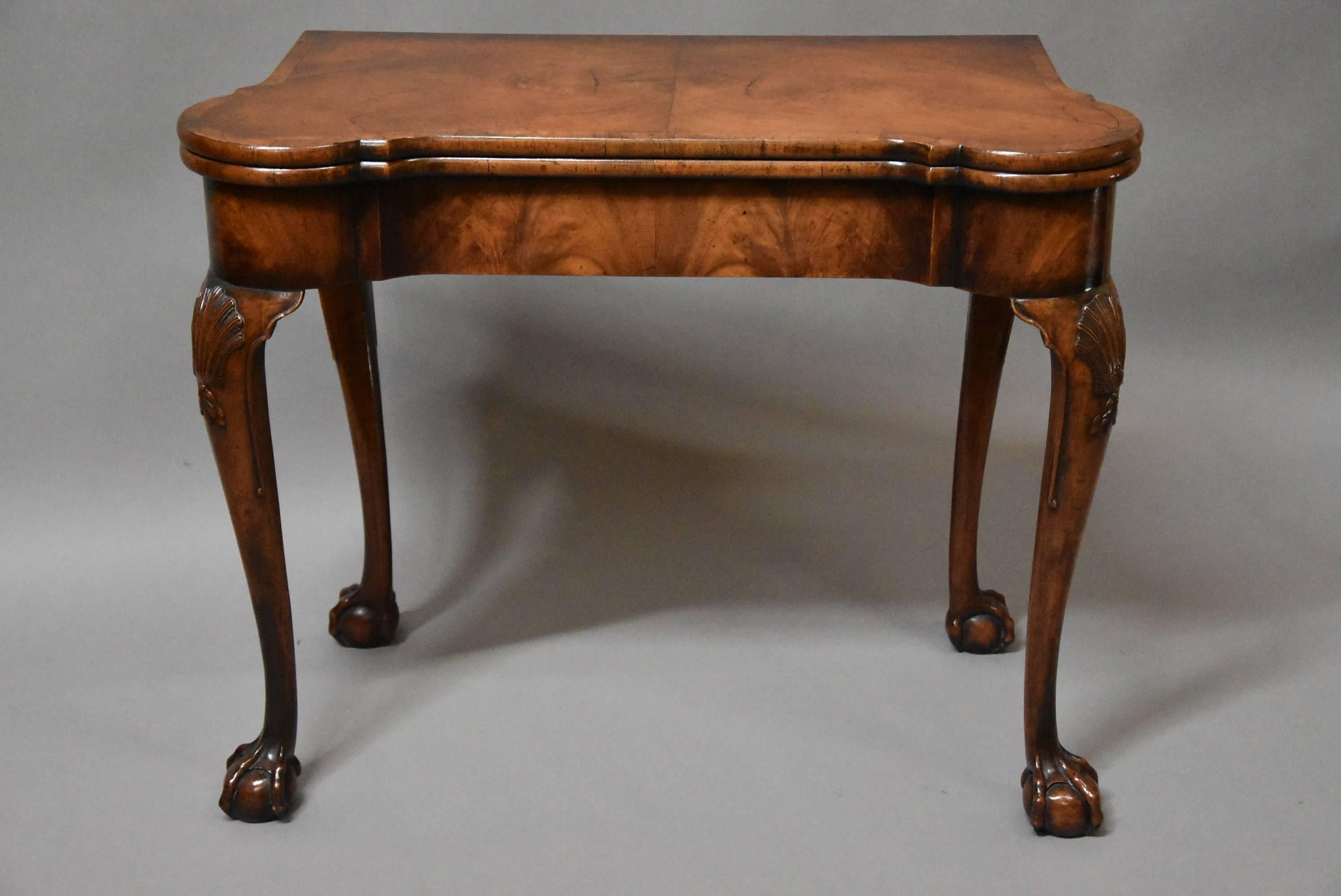 A fine quality early 20th century walnut card table with concertina action in the Queen Anne style.

This table consists of a finely figured mirror veneered walnut top with cross grain banding and rounded corners leading down to a figured walnut