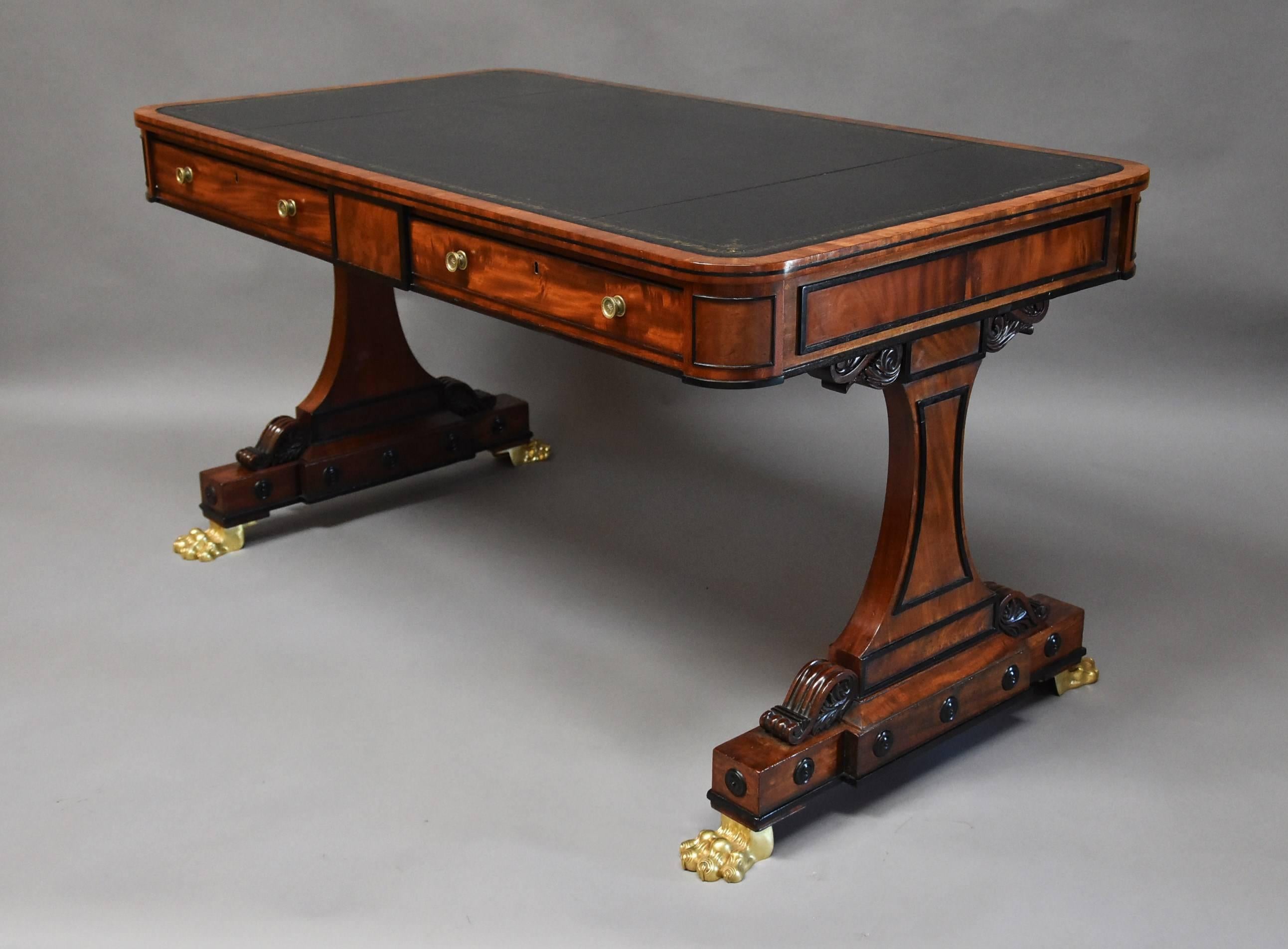 A fine quality Regency mahogany writing table of rectangular form.

This table consists of a black leather tooled top surrounded by a mahogany crossbanding leading down to a crossbanded mahogany edge with ebony black line.

The two drawers to