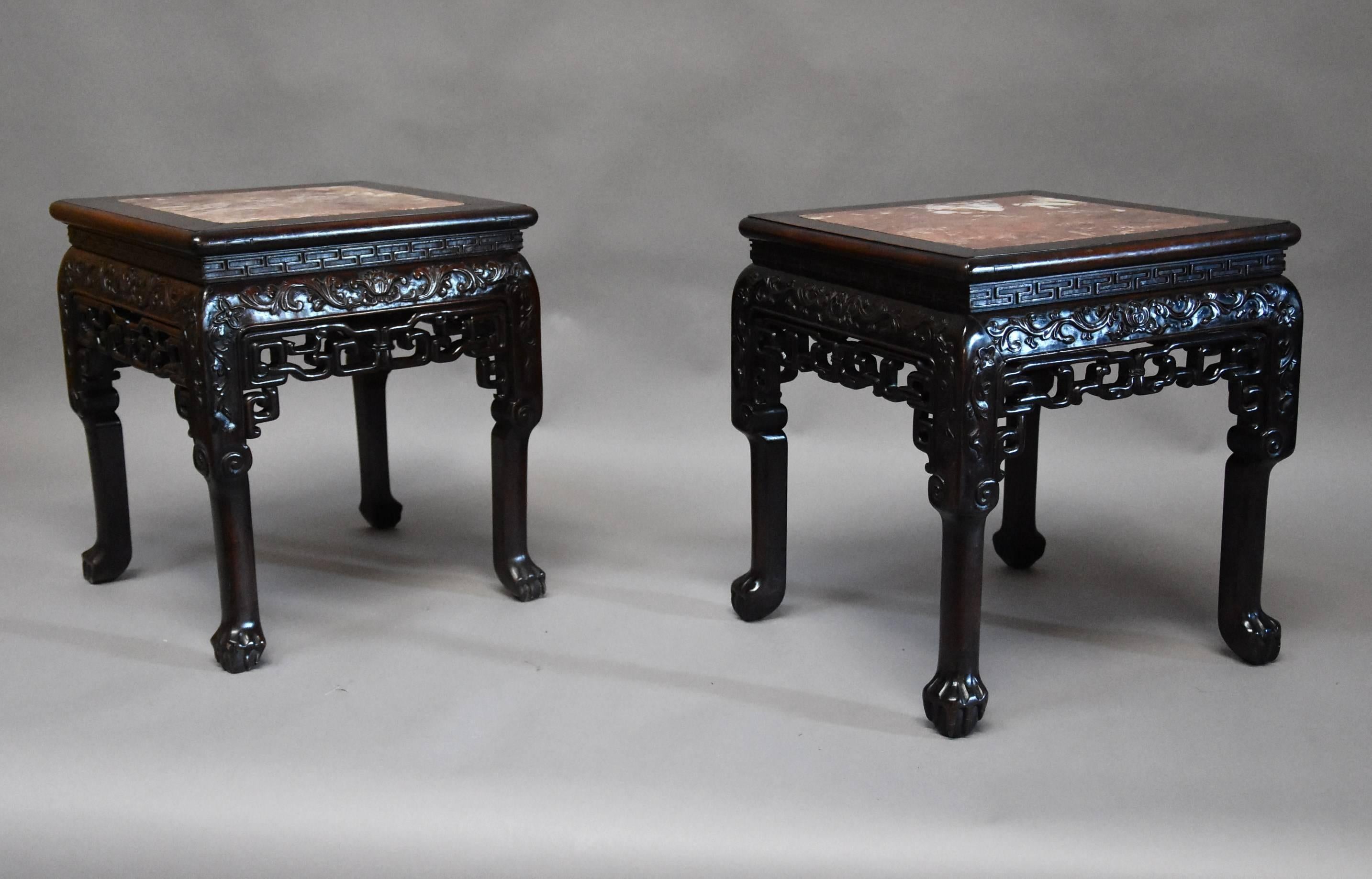 A late 19th century matched pair of Chinese hardwood square pot stands.

These pot stands consist of a rouge marble inset top with a hardwood banding surrounding it leading down to a moulded edge with geometric carved decoration below.

This