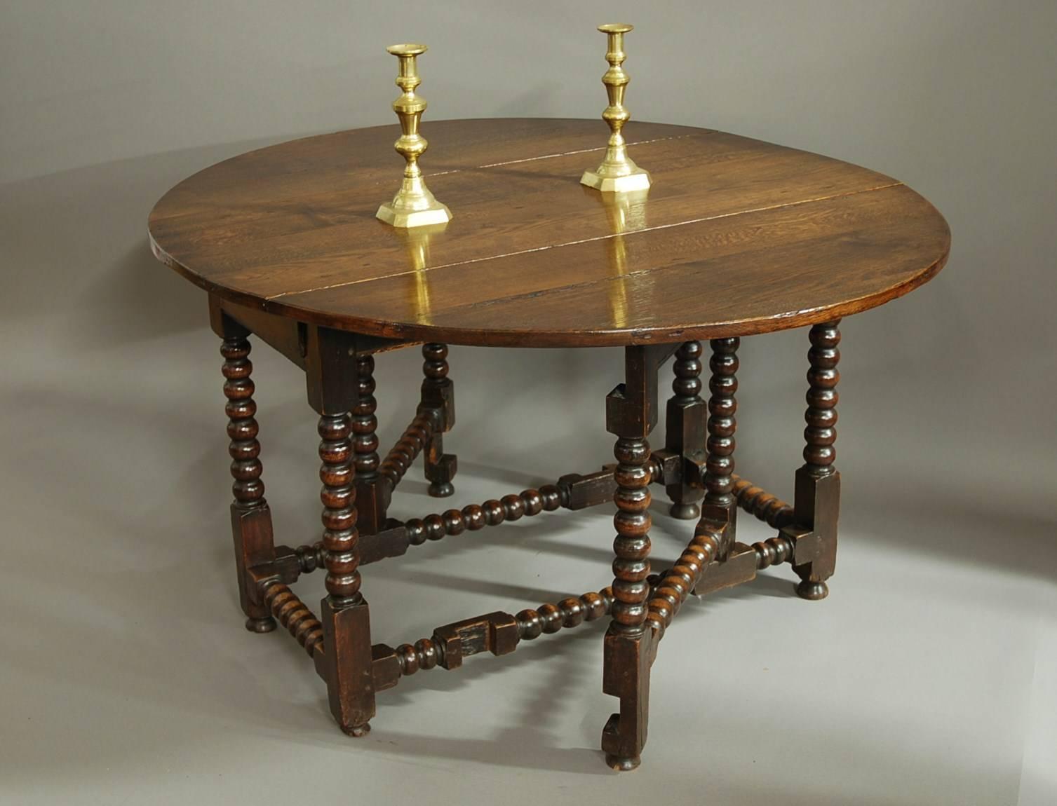 A large 17th century oak gateleg table with bobbin turned legs.

This table consists of an oak plank top with one drawer below and is supported by bobbin turned legs and stretchers.

When purchased the top was a very dull colour so this has been
