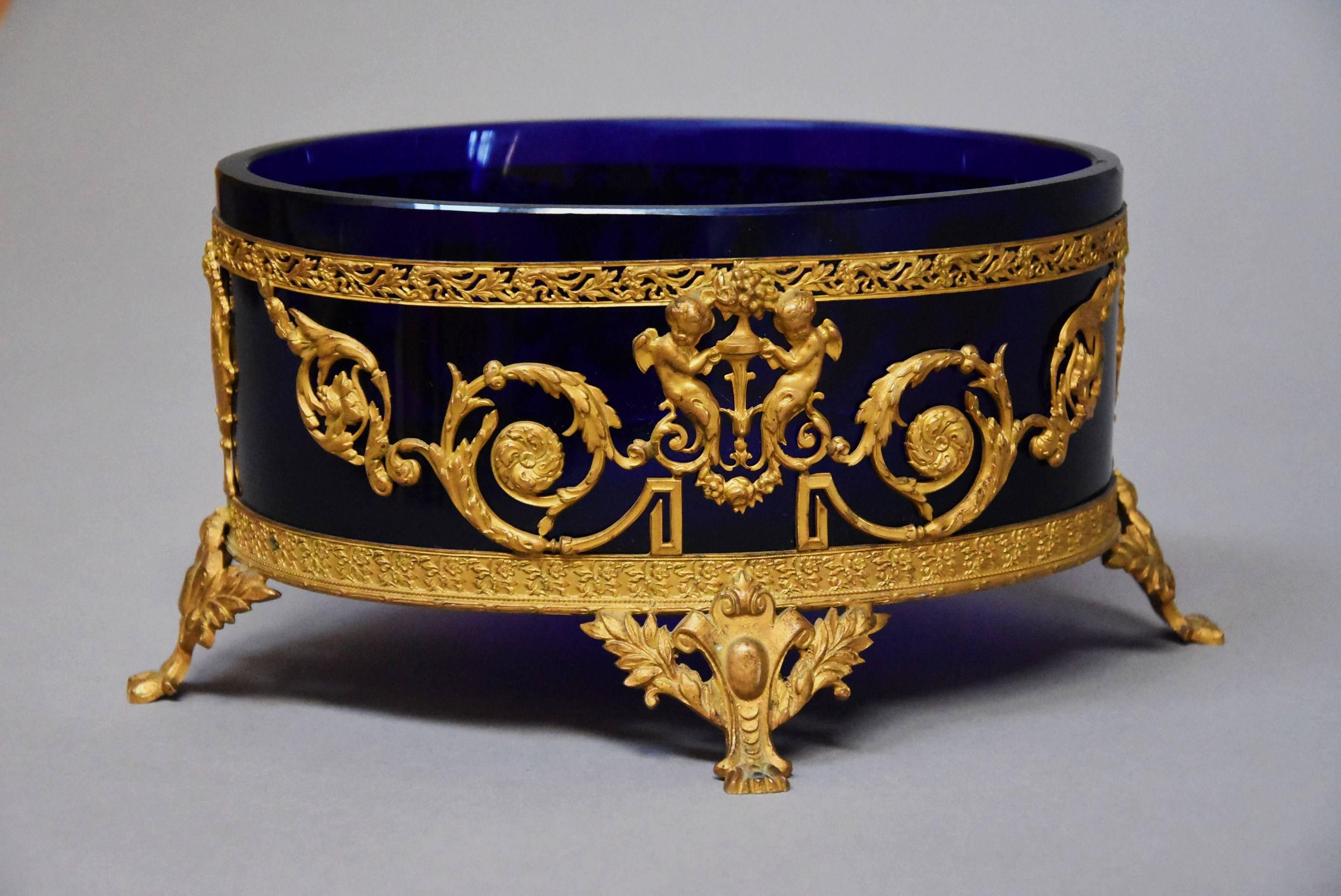 A fine quality late 19th century blue glass and gilt metal centrepiece of oval form in the Classical style, possibly Swedish.

This centrepiece consists of an oval gilt metal (ormolu) holder with oval blue glass liner in good condition for