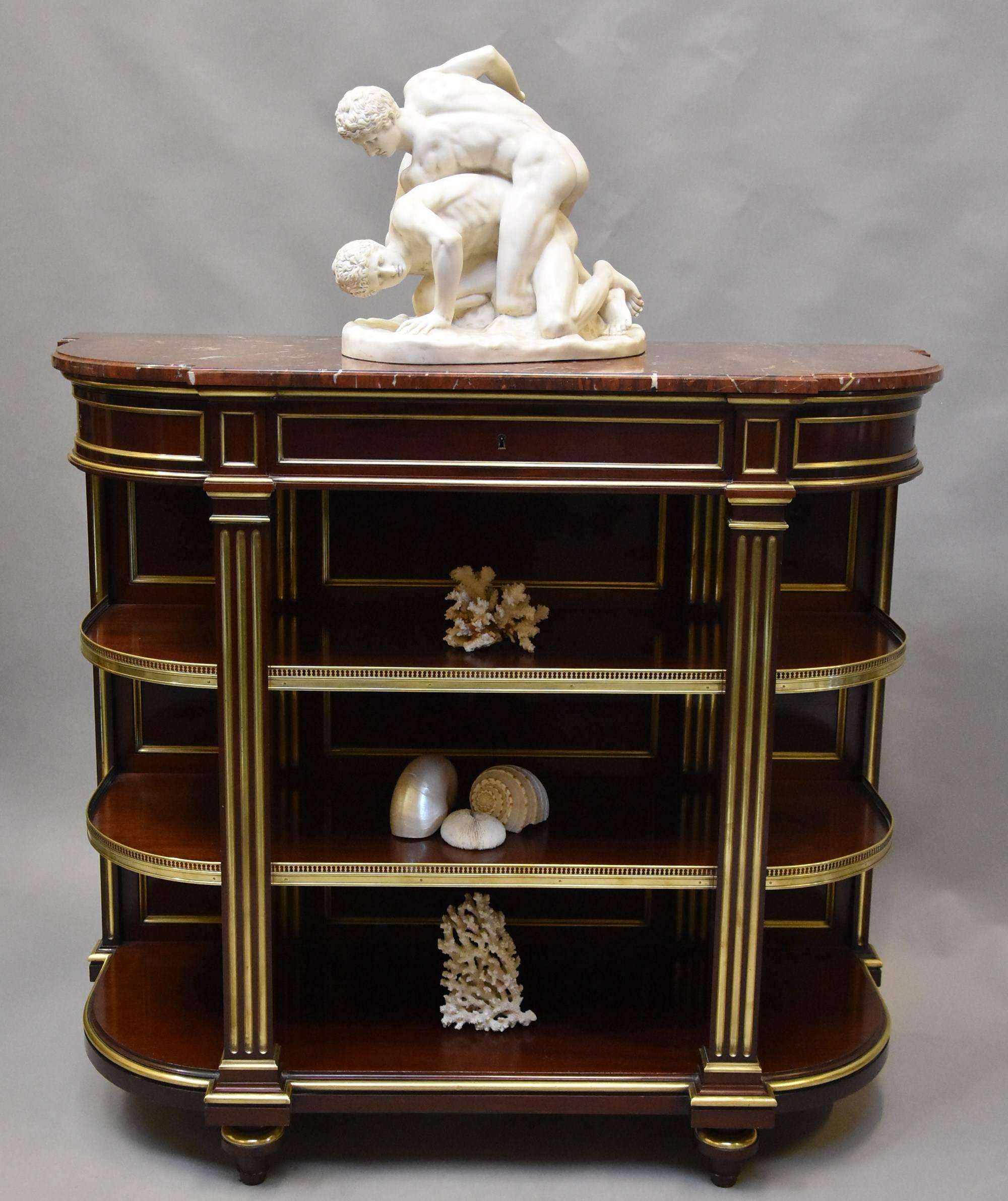 An excellent quality late 19th century, French Empire mahogany and brass étagère with marble top.

This étagère consists of an original shaped and moulded rouge marble top leading down to a frieze with three concealed drawers all with brass