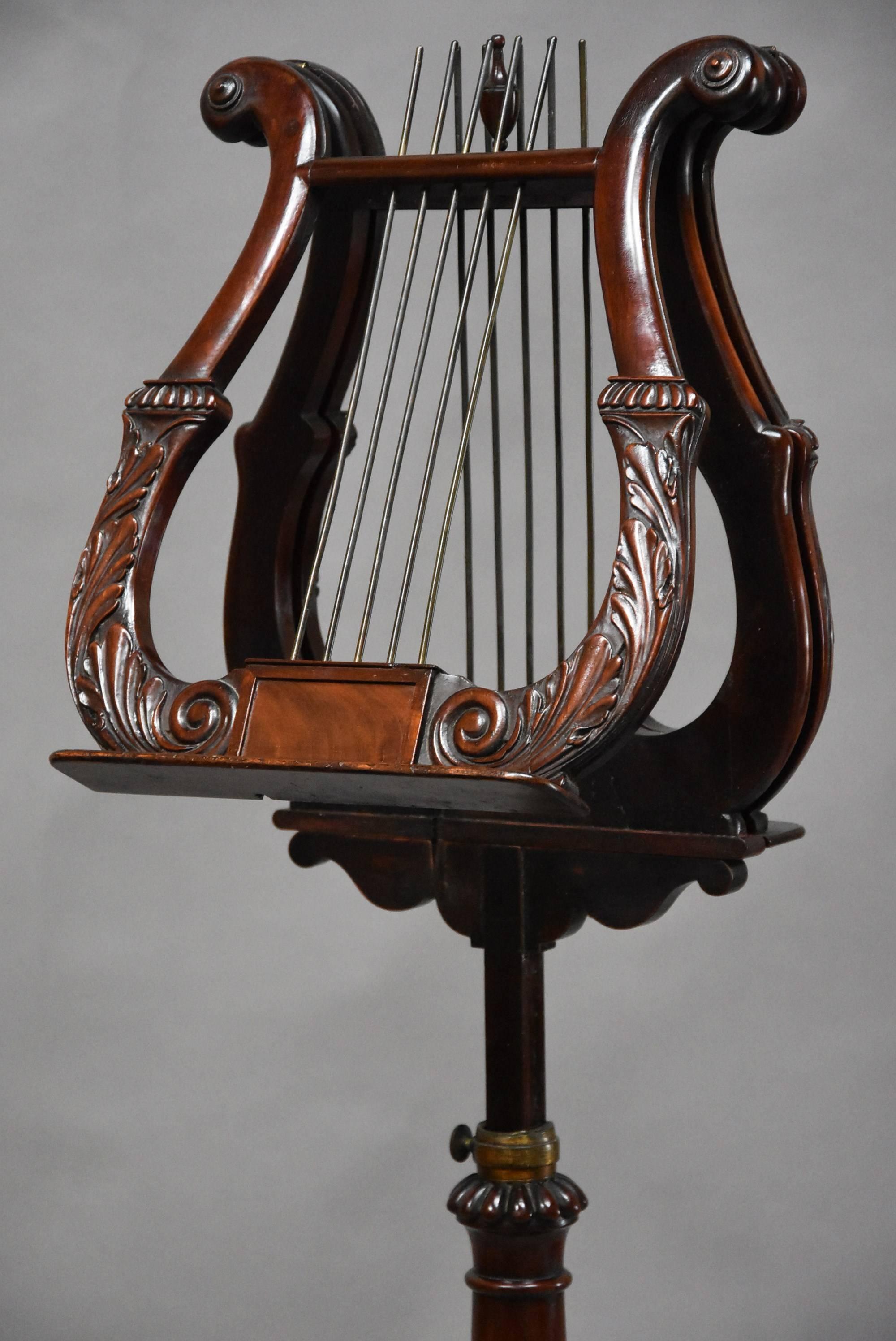 A late Regency mahogany lyre duet music stand of excellent quality.

This duet stand consists of two finely carved adjustable lyre supports with applied paterae to the top, gadrooned carving with scrolling leaf decoration below with central panel