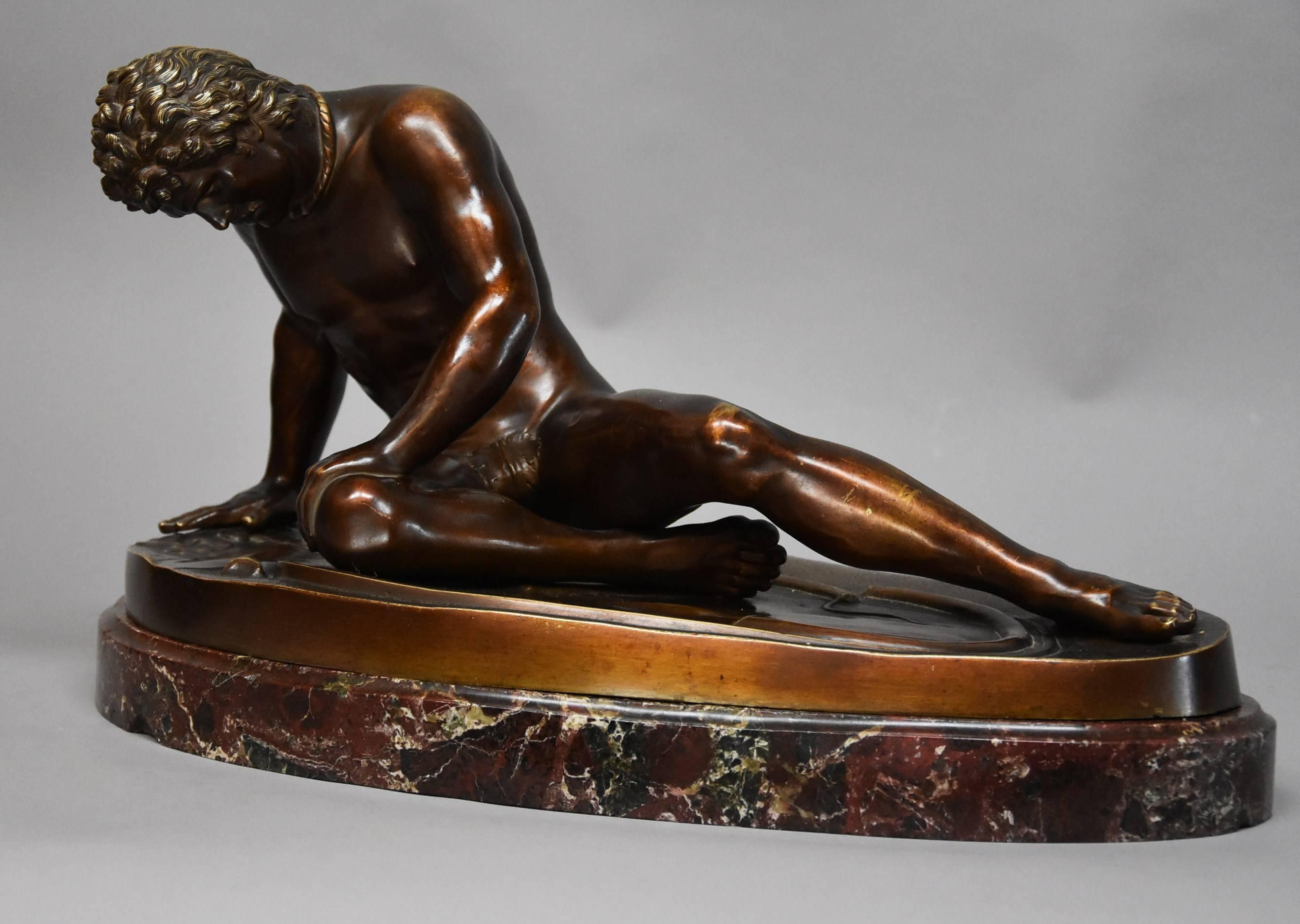 A large late 19th century Grand Tour bronze figure of 'The Dying Gaul' supported on an original Breccia rossa marble oval base, after the antique, possibly Italian.

The dying gaul or dying gladiator is depicted in his final moments next to his