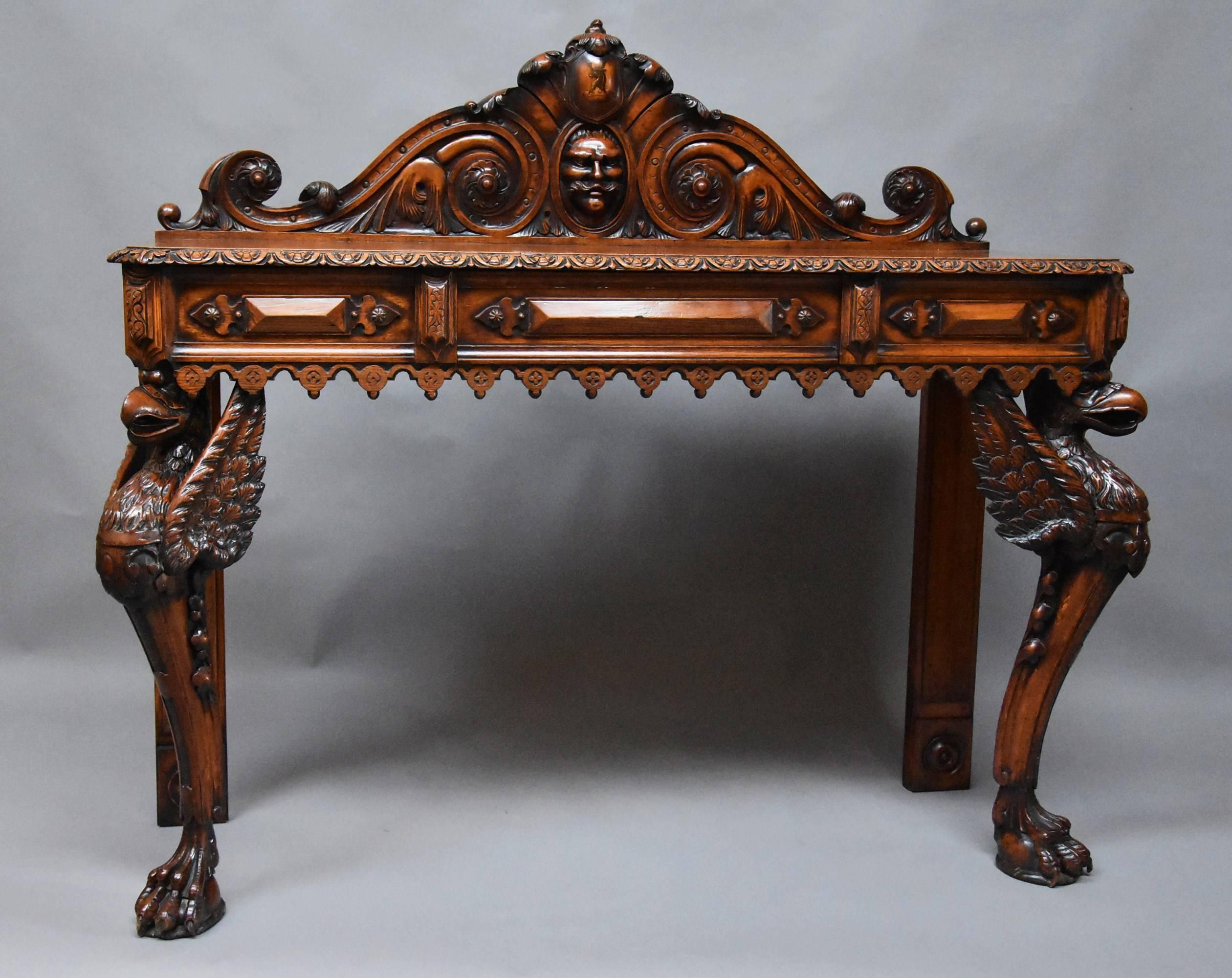 A wonderful quality and superbly carved mid-19th century oak hall table.

This finely executed table consists of a superbly carved and shaped back board with central painted armorial of a stag and crown to the top.

This leads down to an oval