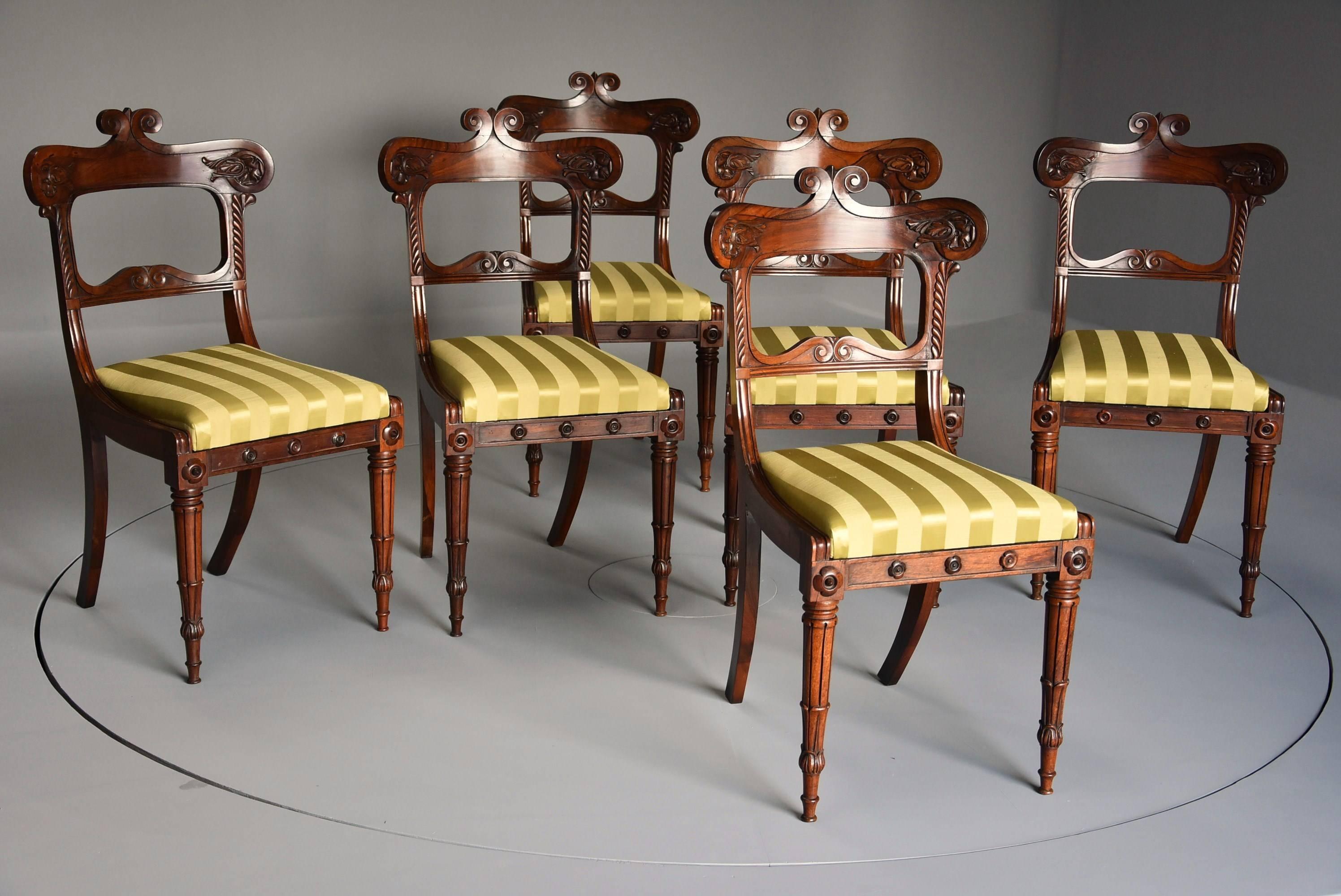 An early 19th century fine quality set of six Regency rosewood dining chairs.

This set of chairs each consist of a wide top rail with scrolling decoration with finely carved rosette and foliate decoration.

The side supports have gadrooned