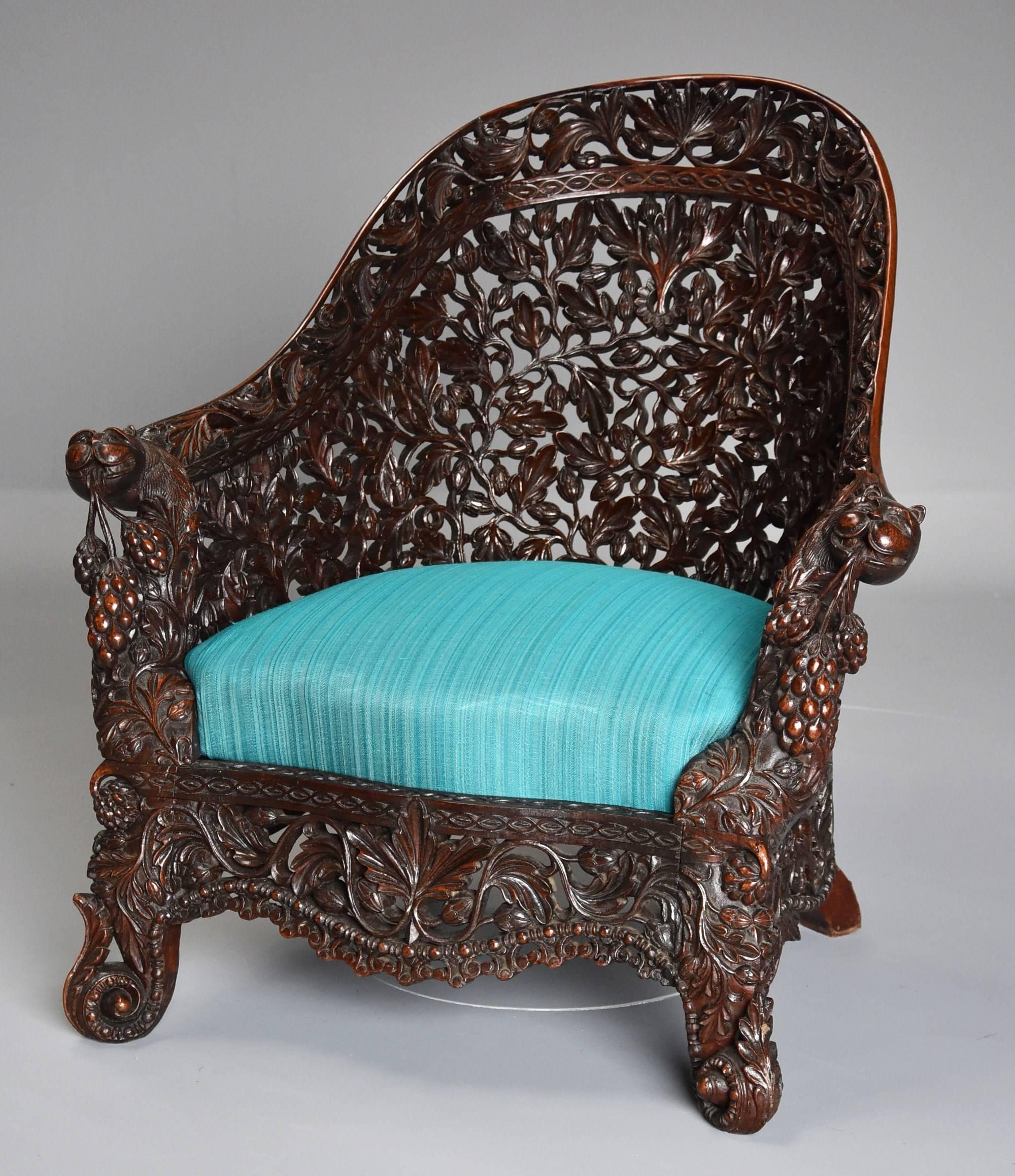A rare and highly decorative mid-19th century profusely carved blackwood armchair of superb quality from the Bombay area of India.

This chair consists of a profusely carved and pierced arched and shaped back with an outer border depicting