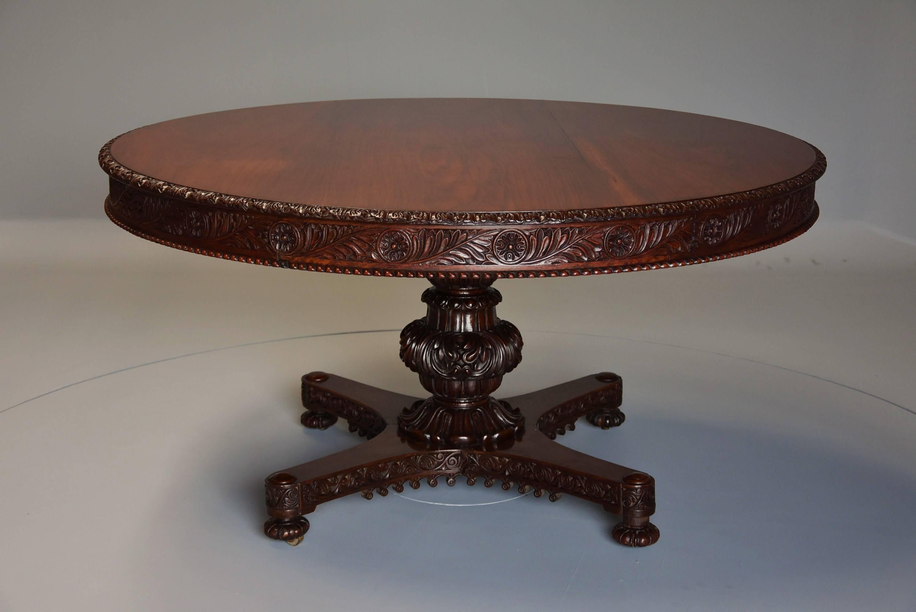 A large mid-19th century Anglo-Indian padouk superbly carved circular centre table.

This table consists of a solid circular padouk top with carved leaf edge leading down to a carved frieze with circular roundels and scrolling foliage with a