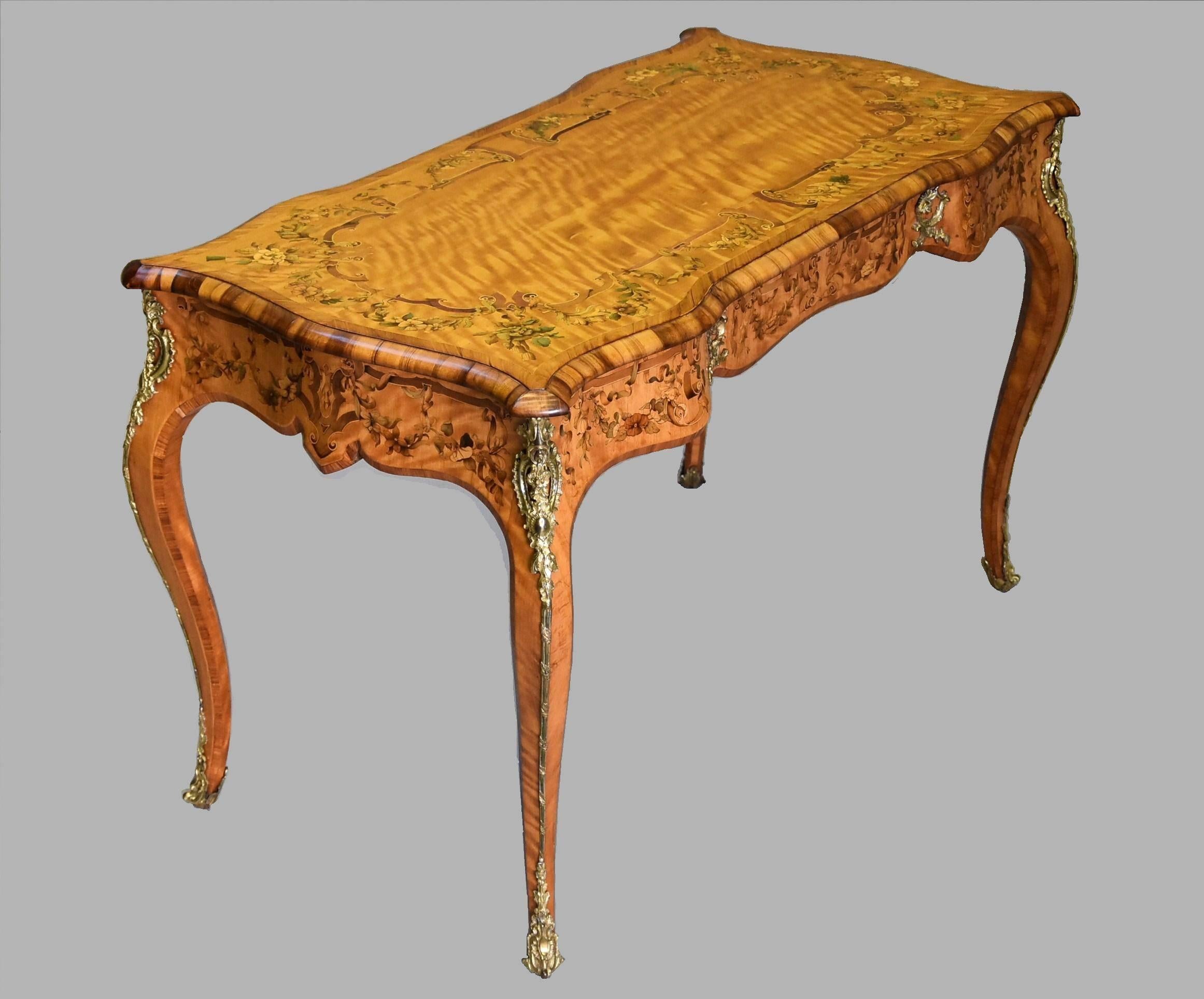 A mid-19th century superb quality satin birch and marquetry bureau plat or writing table with ormolu mounts attributed to Edward Holmes Baldock (1777-1845) and the Blake family.

This bureau plat consists of a superb satin birch top inlaid with