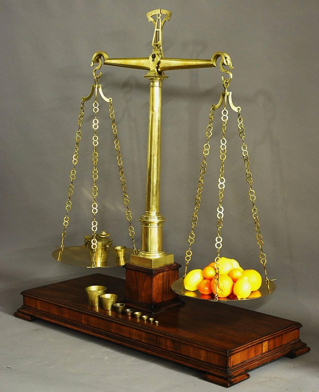 A large and highly decorative pair of 19th century brass apothecary balance scales with 19th century brass apothecary weights, possibly French.

The scales have an arrow to the top which points to the appropriate weight with horizontal beam and a