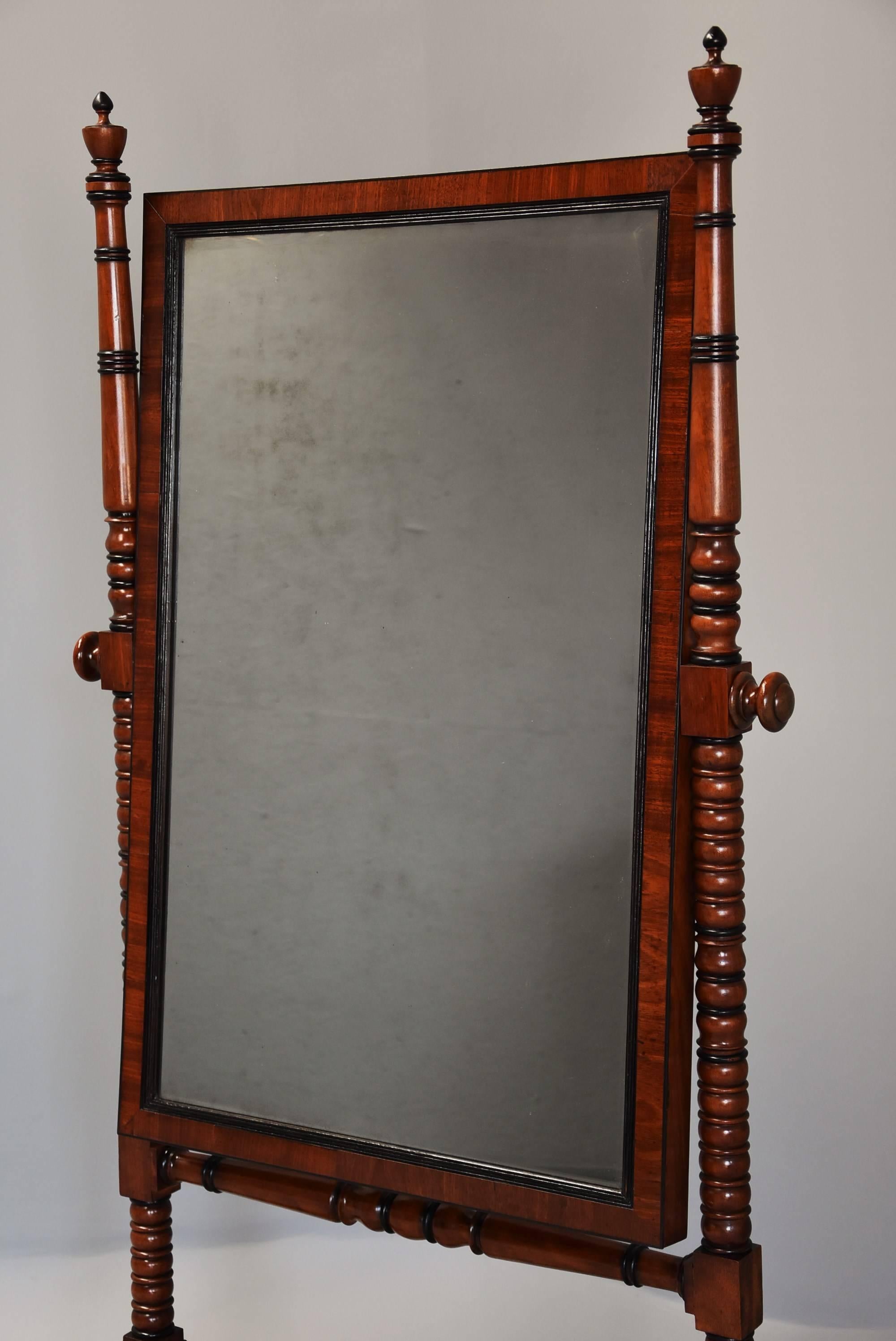 An early 19th century fine quality Regency mahogany cheval mirror.

The mirror frame consists of an ebonized and reeded moulding with mahogany cross banding surrounded by ebony stringing, the mahogany panelled back confirming the superb quality of
